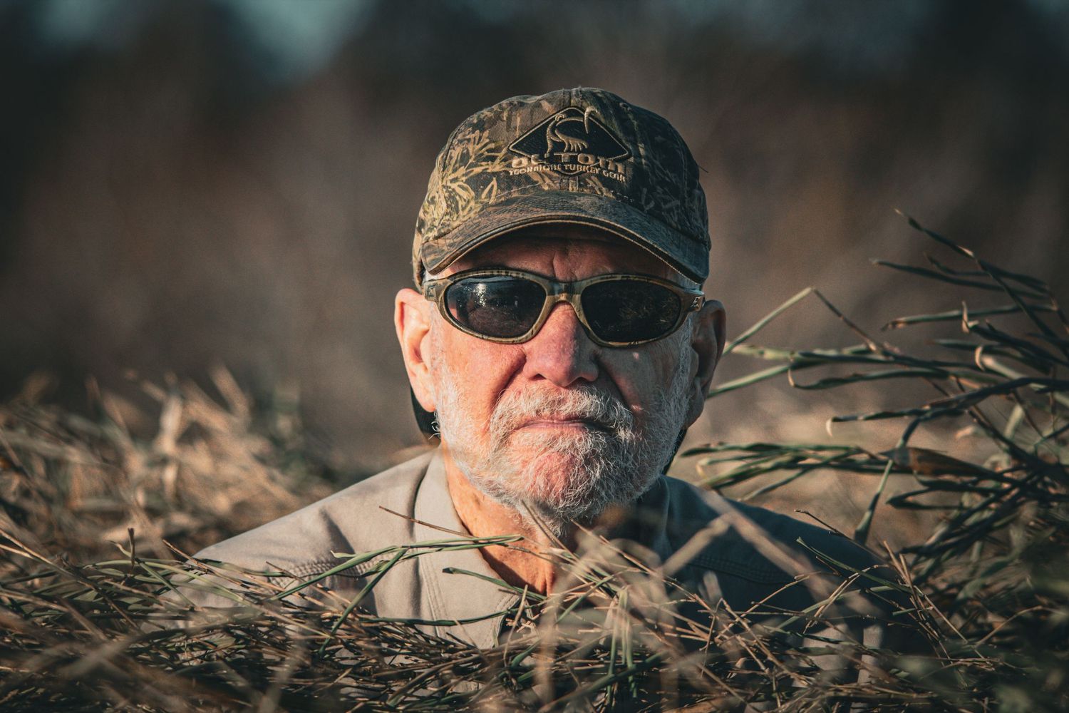 Close-up portrait sequence of someone wearing sunglasses and a cap in an outdoor setting.