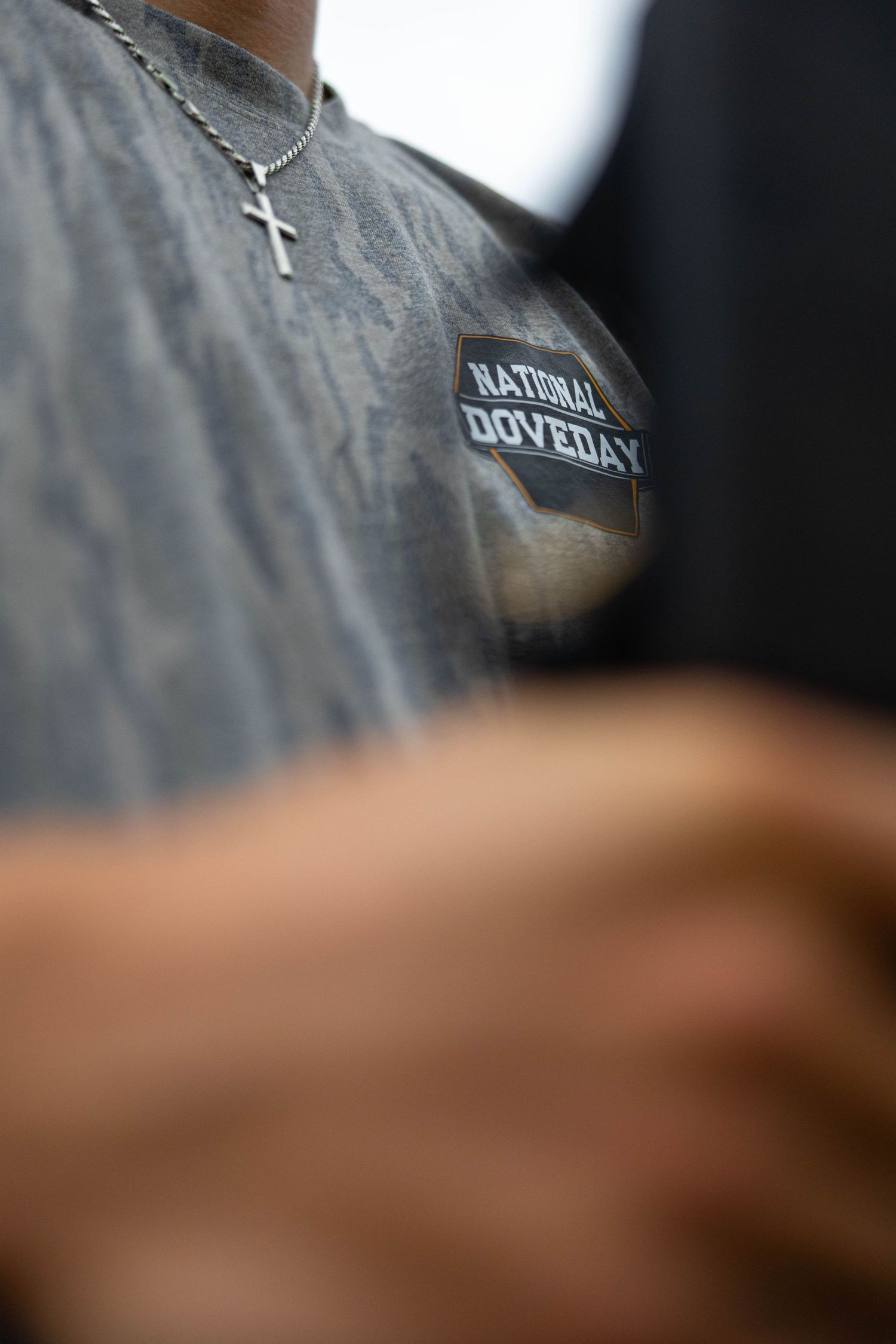Close-up view of a blurry text logo on a dark surface with partial lettering visible.