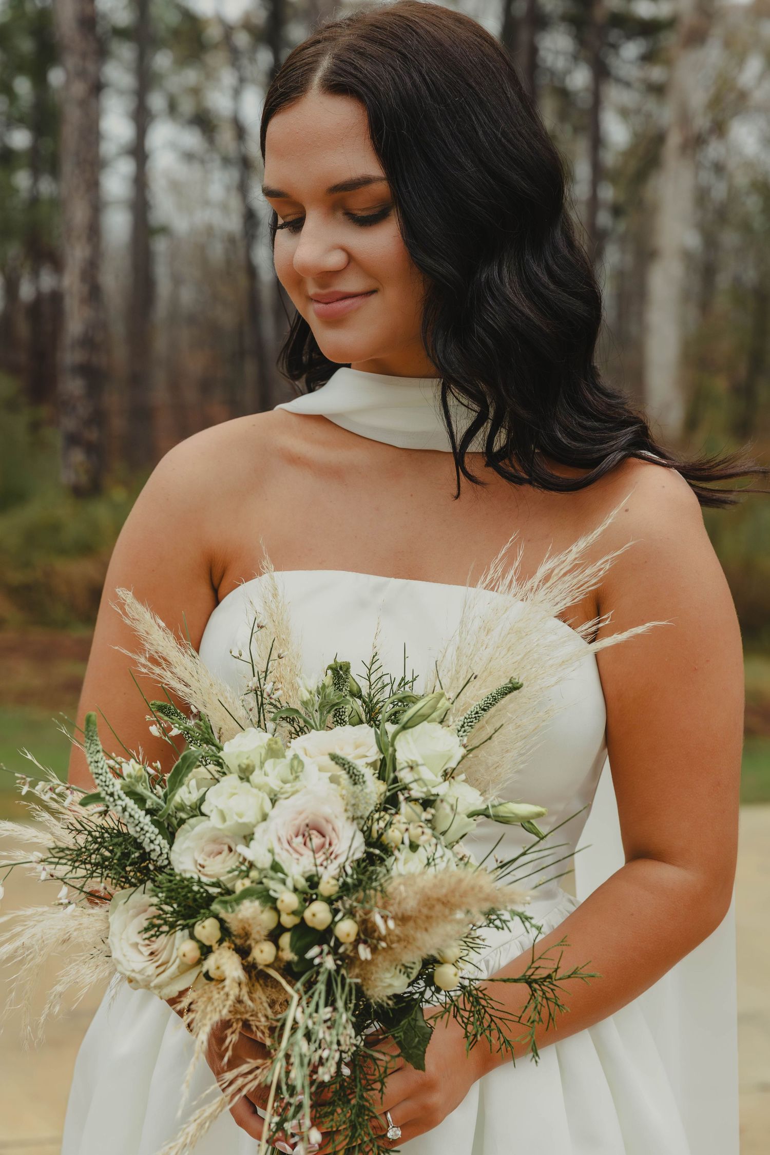 A close-up series of a bridal bouquet featuring white roses, pampas grass and greenery against a natural outdoor backdrop.