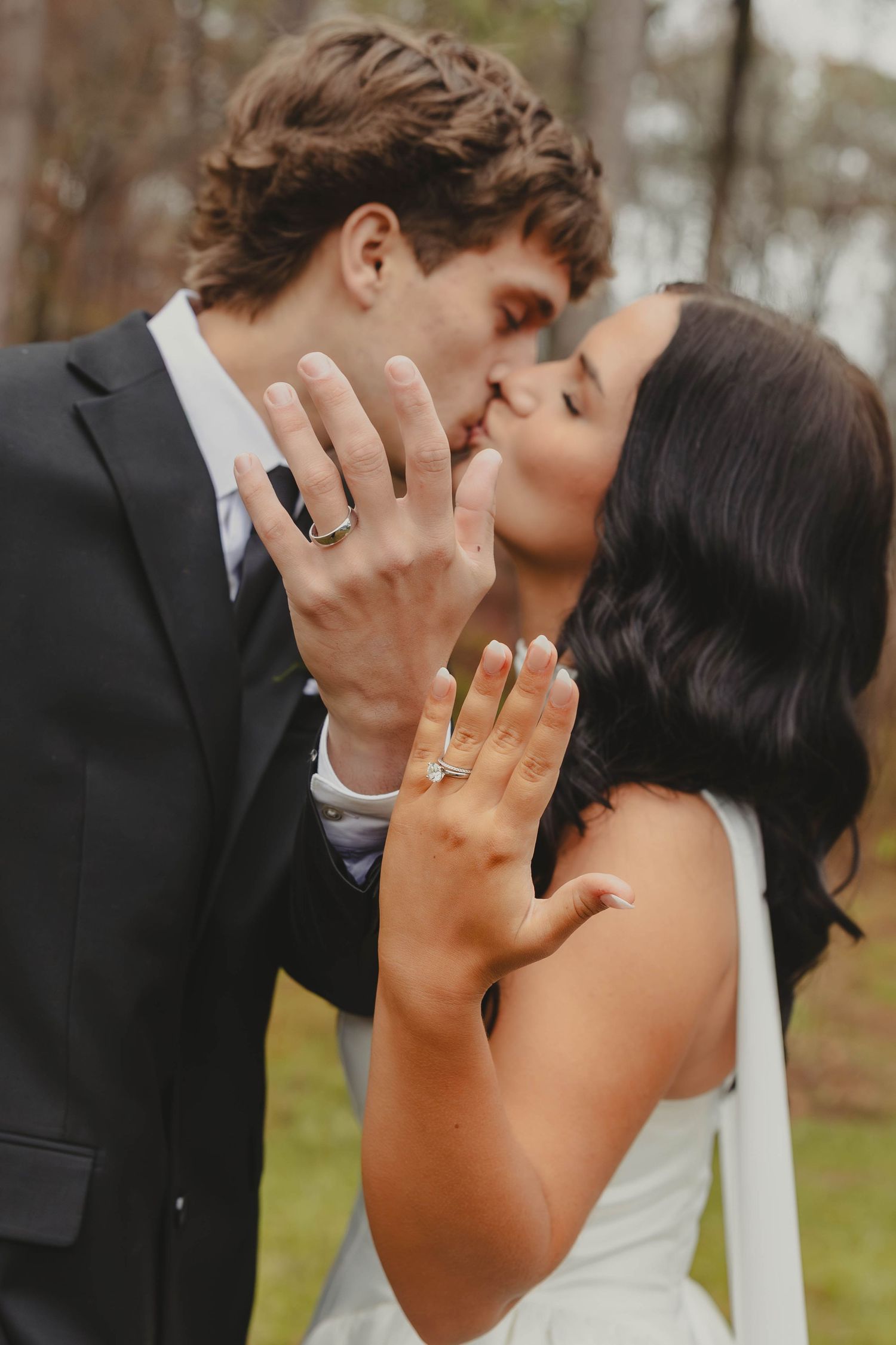 A romantic wedding kiss sequence showing multiple angles of a couple embracing while displaying their rings.