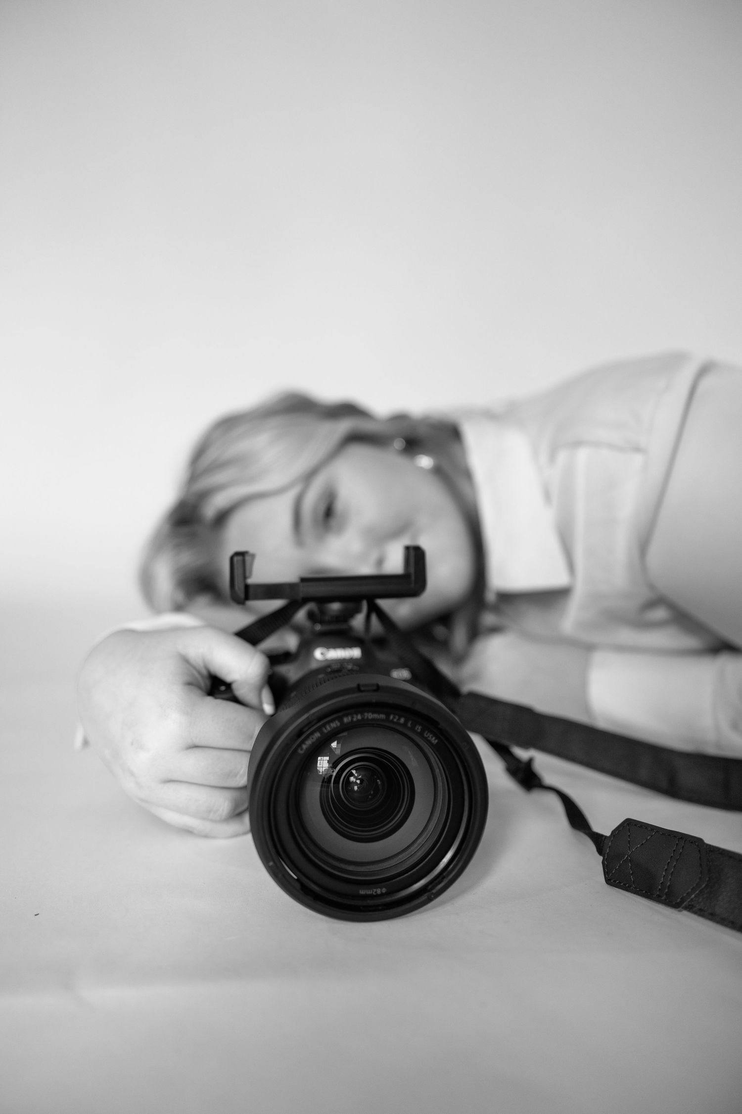 A series of black and white photos showing a camera lens at different angles on a white surface.