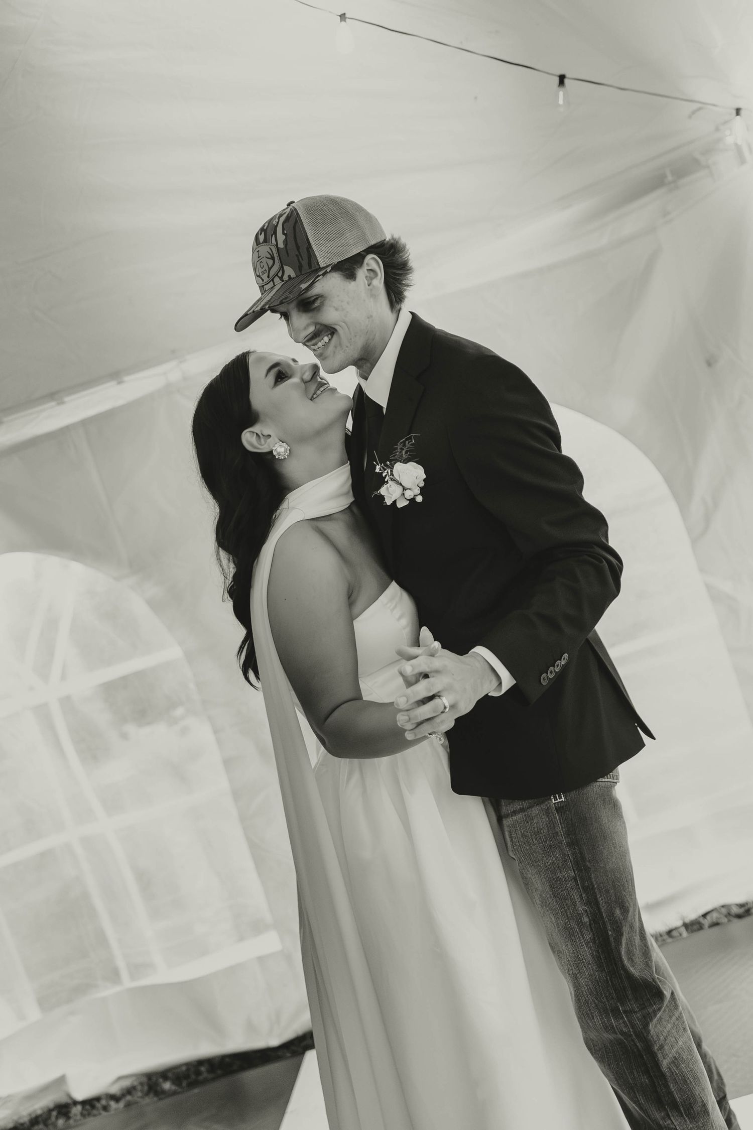 A sequence of romantic dance poses captured in black and white under a white tent ceiling.