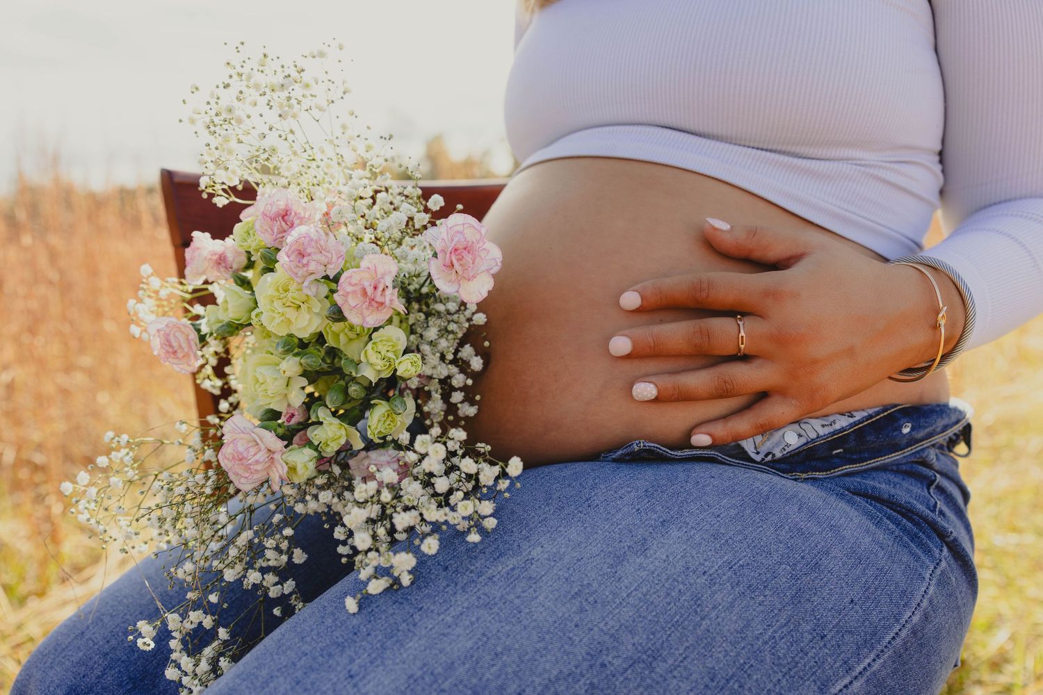 Close-up detail of baby's breath flowers and denim clothing.