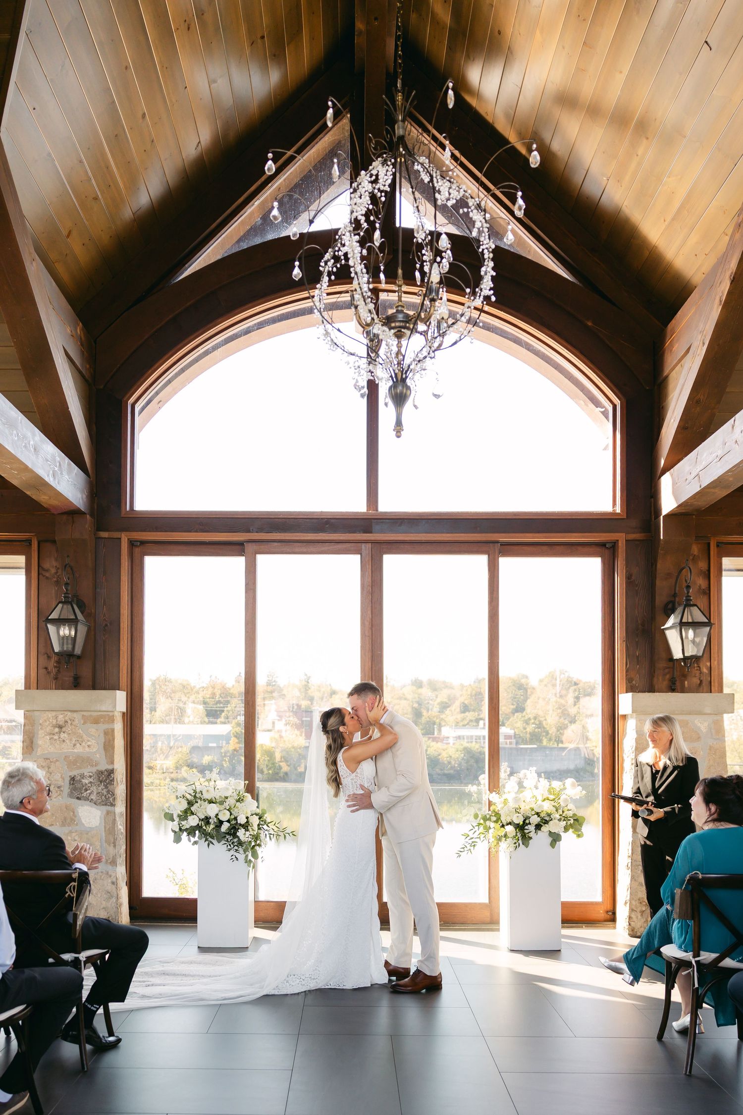 Wedding ceremony sequence in elegant venue with vaulted ceilings and panoramic windows.