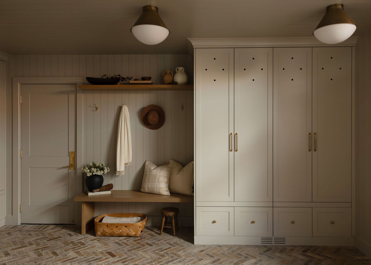 Laundry room with vertical shiplap walls and built-in storage solutions.