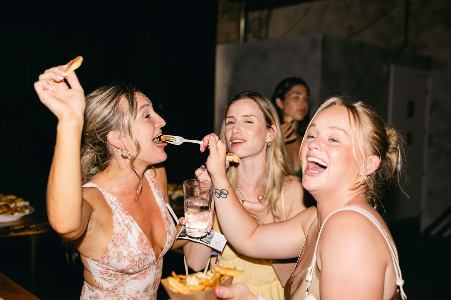 Wedding guests enjoying drinks and celebrating together at reception.