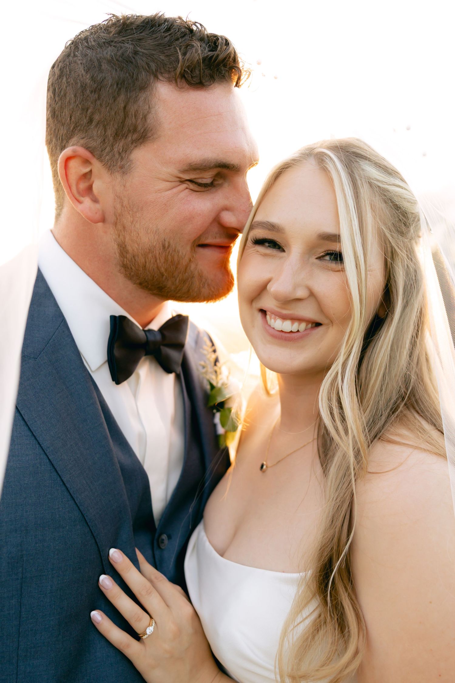 Intimate wedding portraits captured in warm golden sunlight.