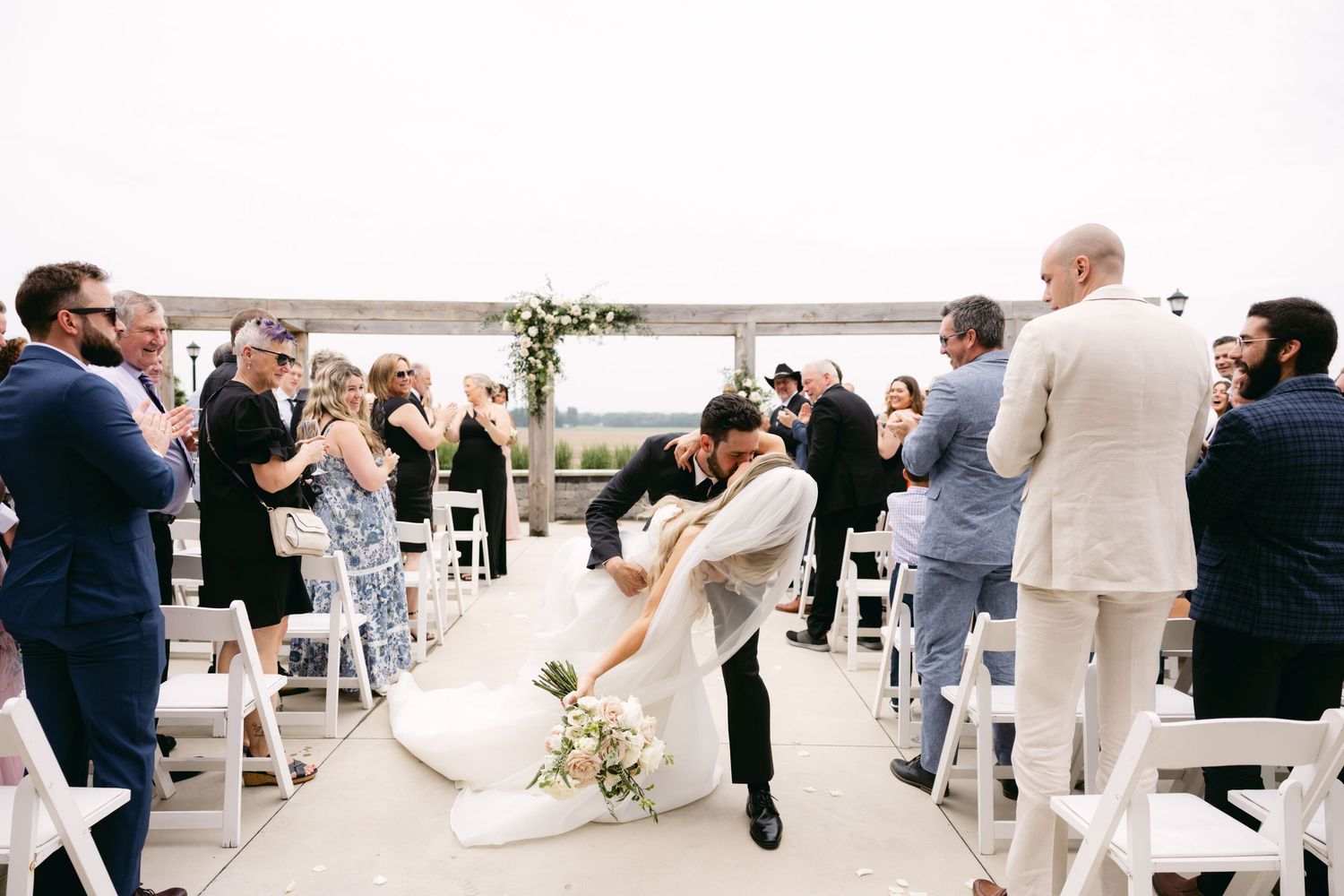 Guests celebrating and dancing at an outdoor wedding reception venue.