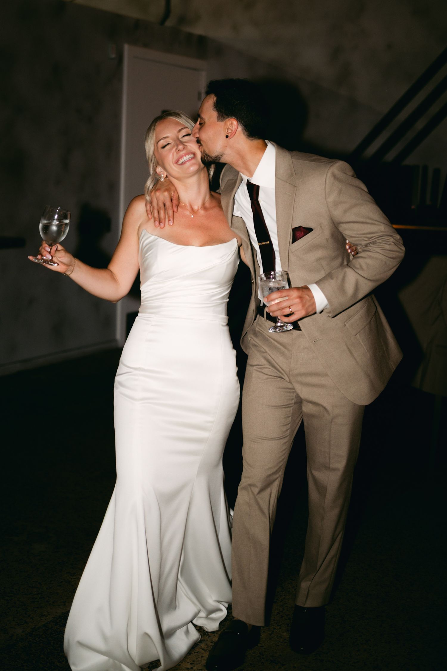 Couple dancing together in formal attire at their wedding reception.