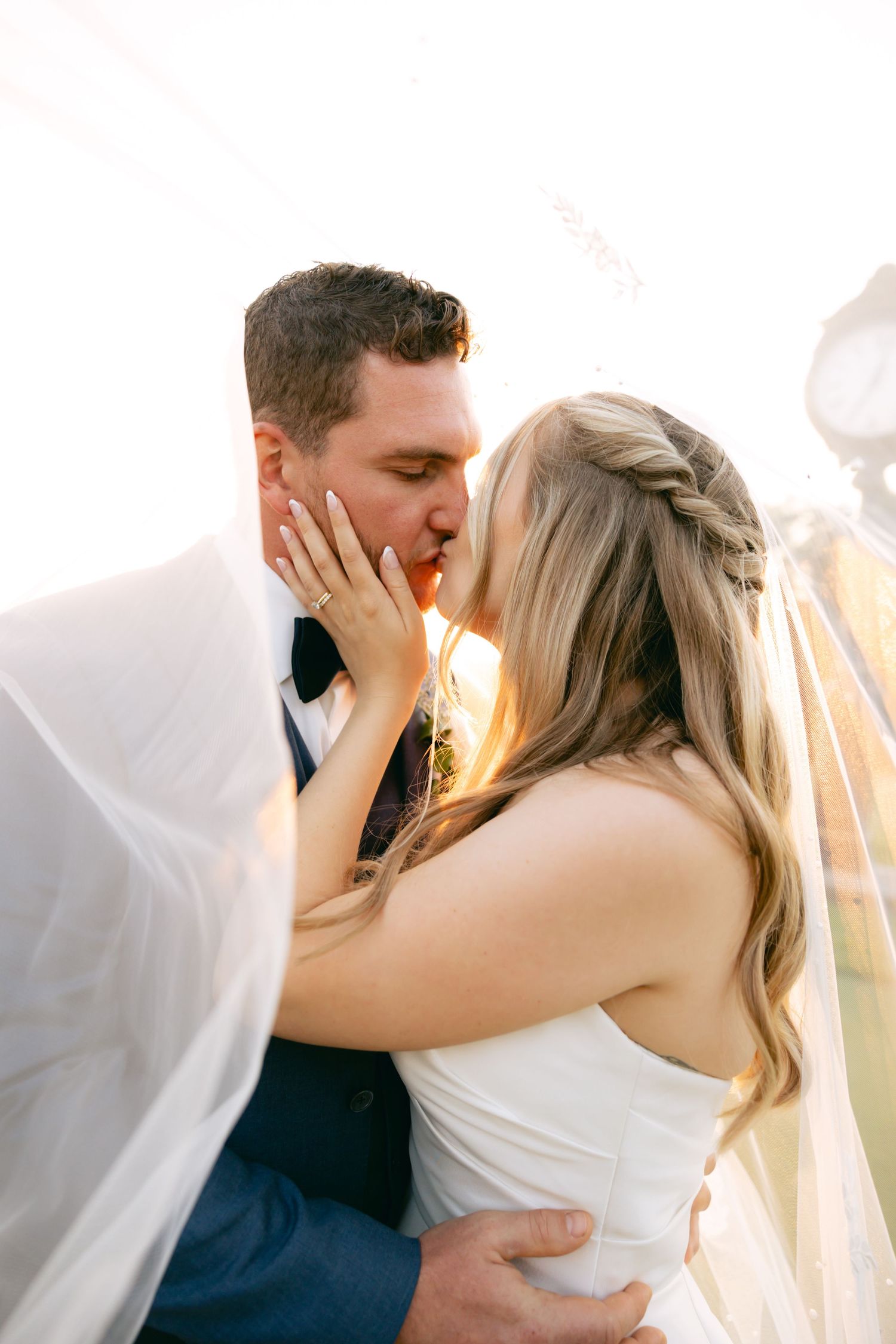 Romantic sunset wedding portraits with soft natural lighting.