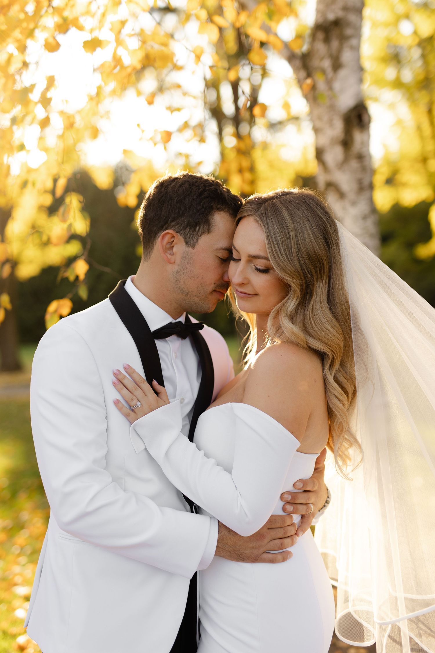 Romantic wedding portraits showing intimate moments between newlyweds in golden light.