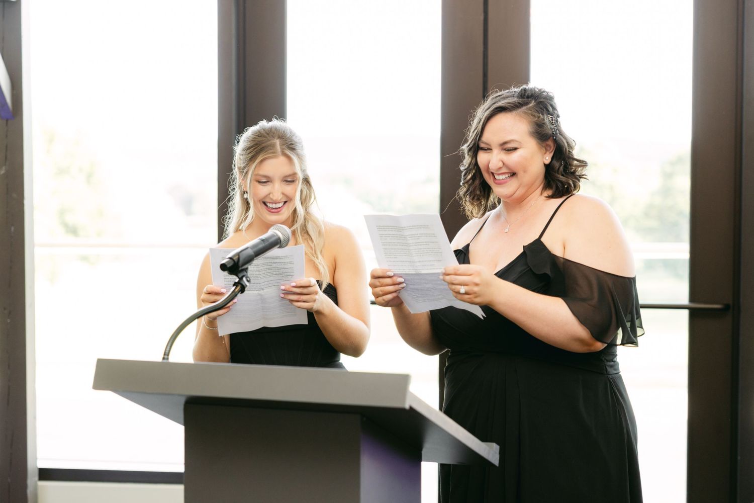 Wedding party members read from papers during indoor ceremony.