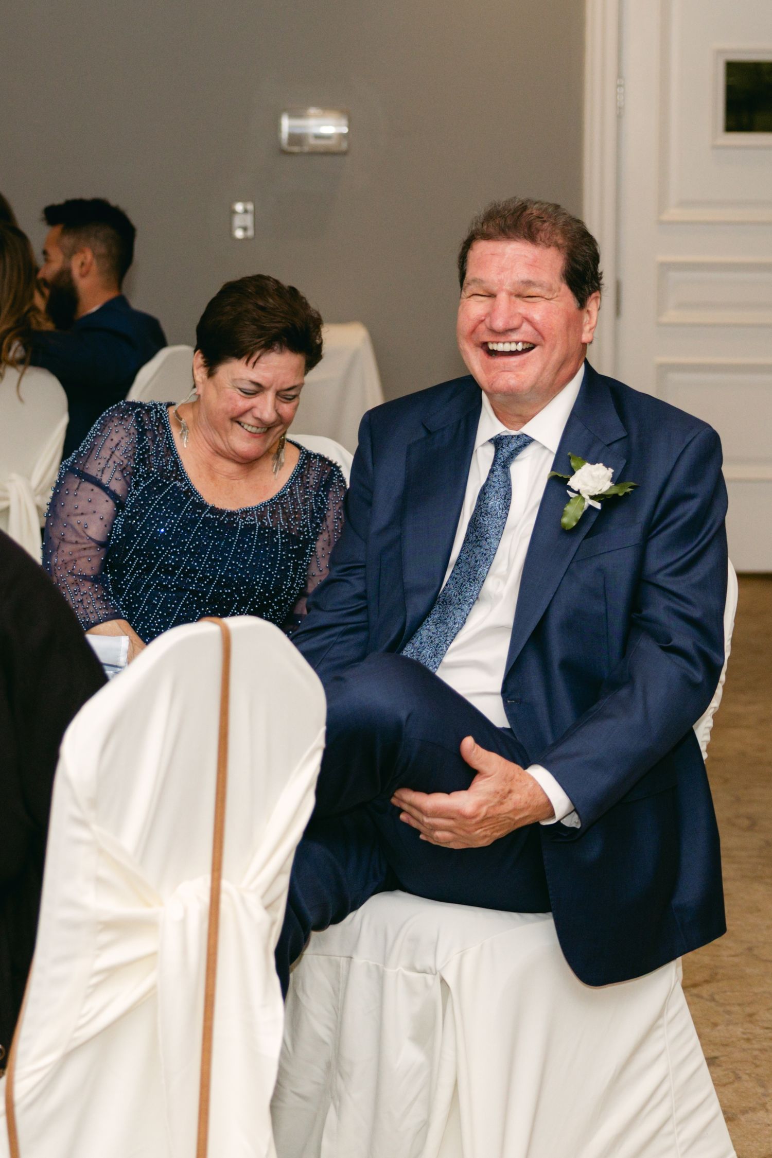Joyful reactions during wedding reception toasts and speeches.