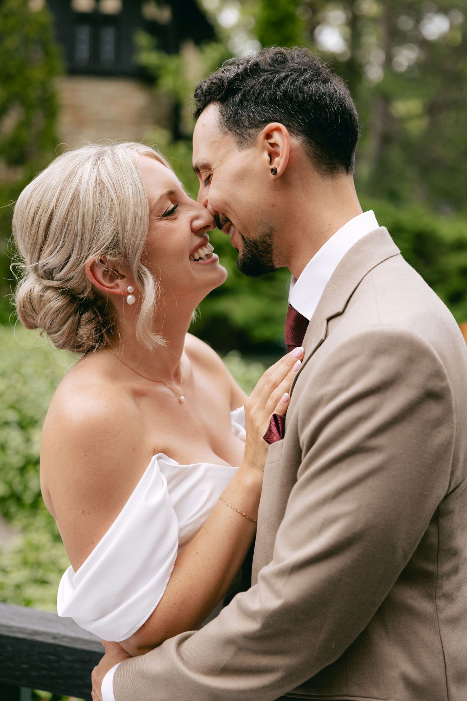 A romantic wedding moment captured in a lush garden setting with natural greenery.