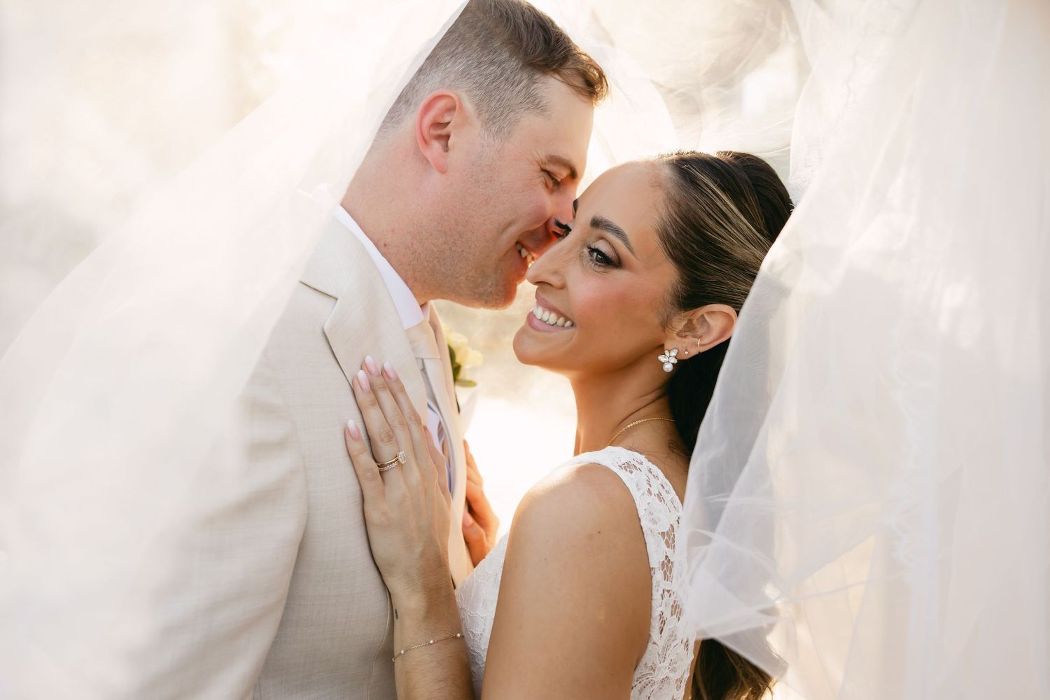 Intimate wedding portrait showing couple's loving embrace in soft lighting.