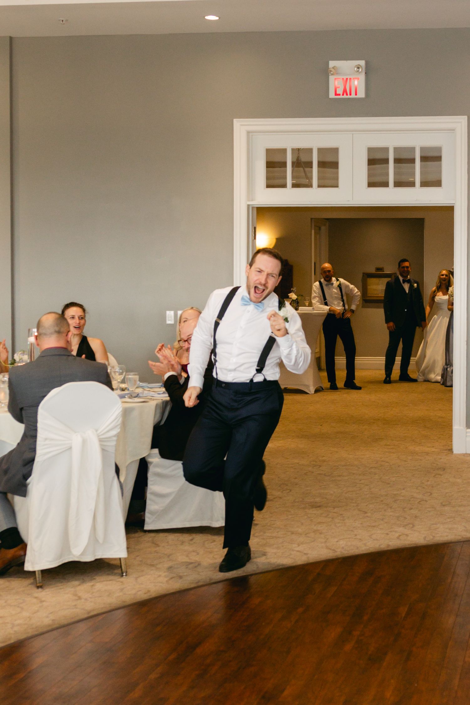 Wedding reception dance floor sequence showing playful dipping moves in an elegant venue.