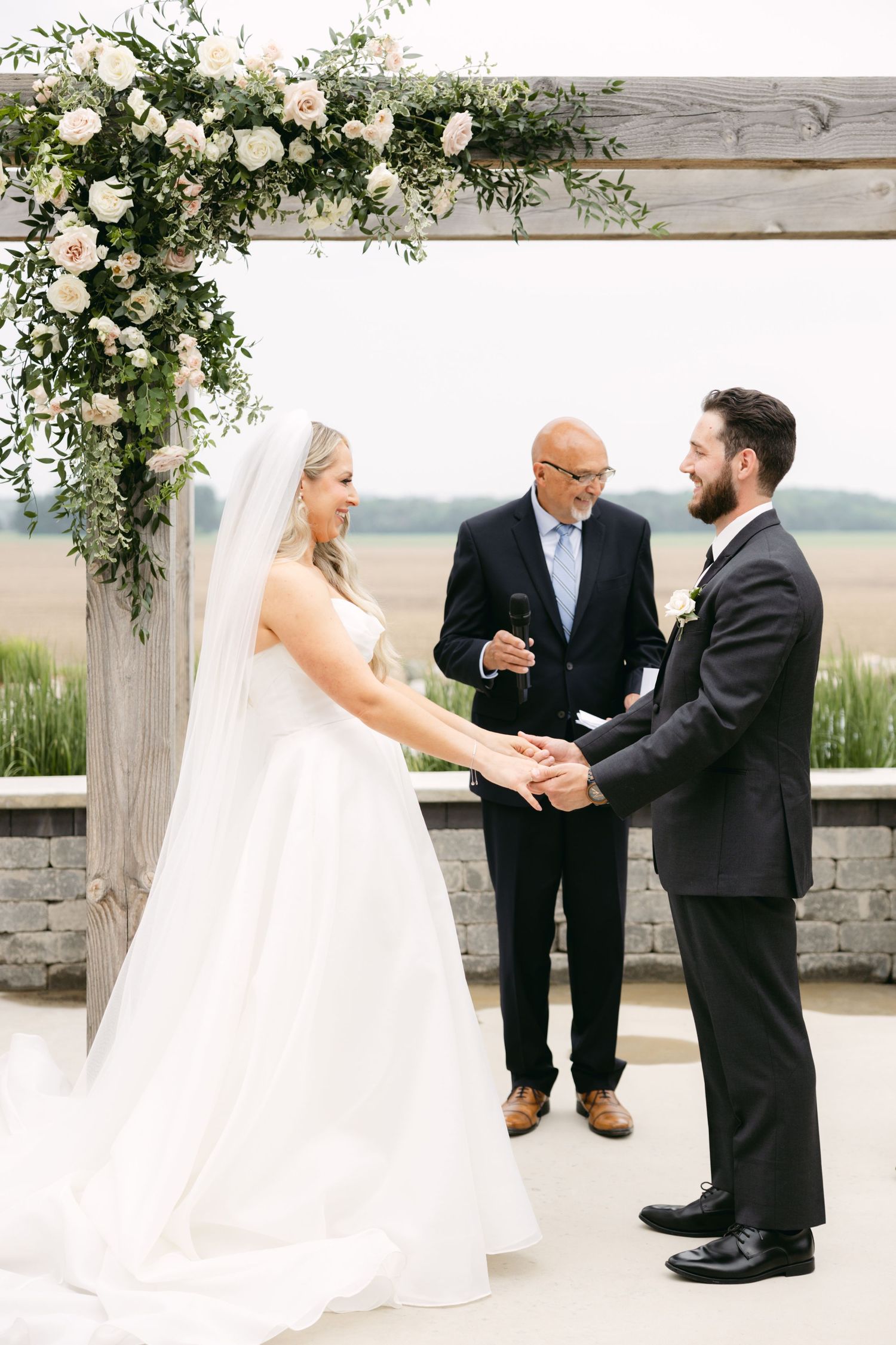 Wedding ceremony sequence showing a couple exchanging vows under a floral-adorned wooden arch.
