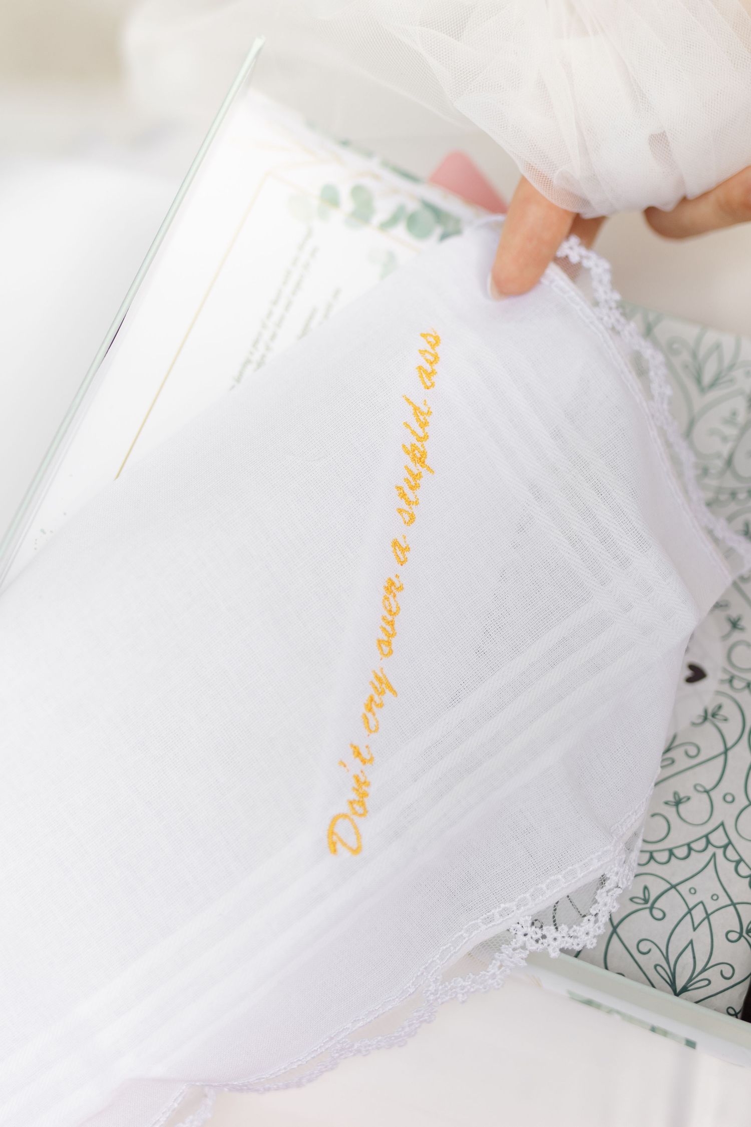 Close-up view of handwritten wedding vows on white paper with decorative border.