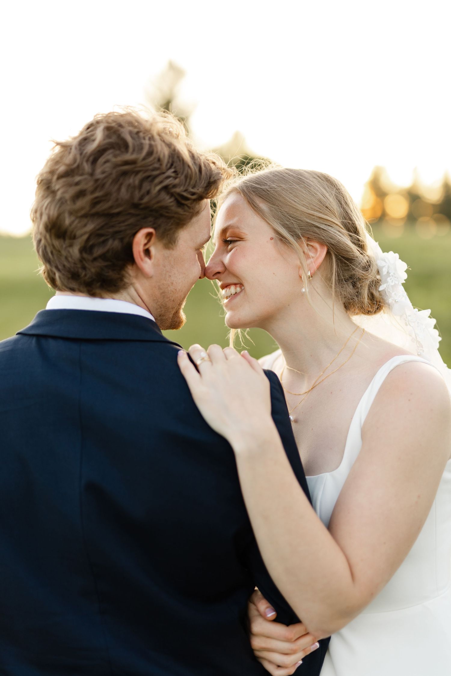 Close-up shots of a tender moment between newlyweds during their sunset photo session.