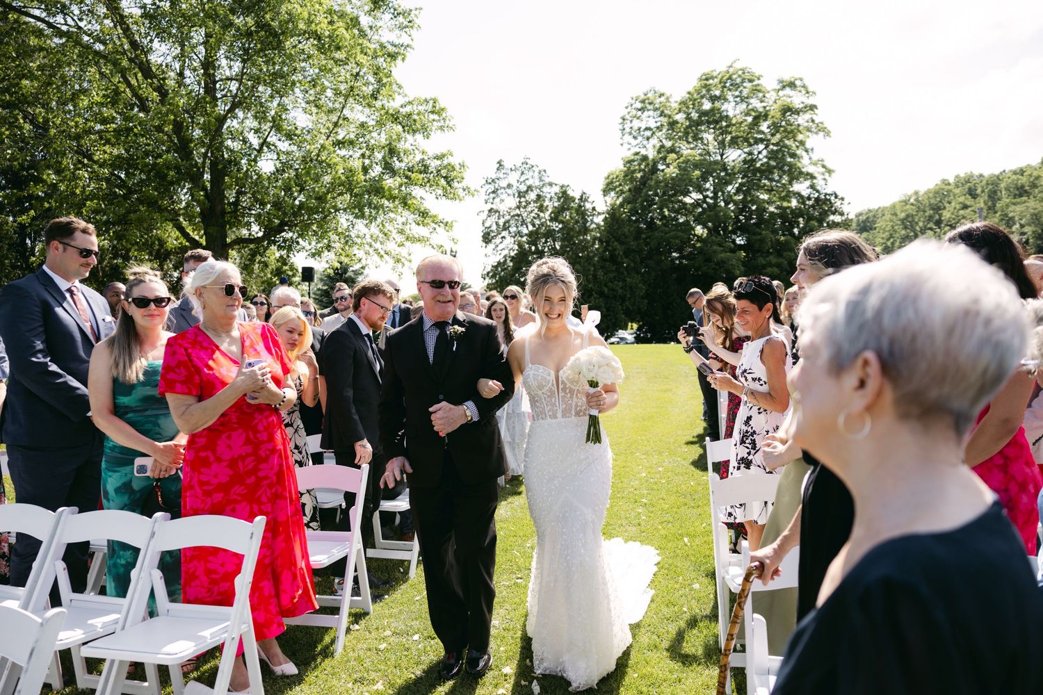 Wedding guests dancing and celebrating at an outdoor reception venue.