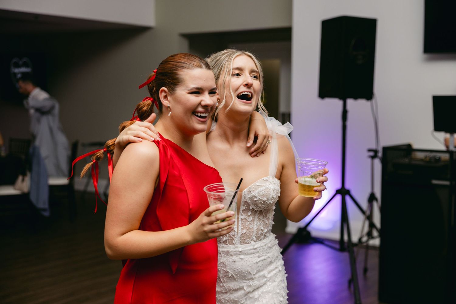Candid moments of laughter and dancing during wedding reception party.