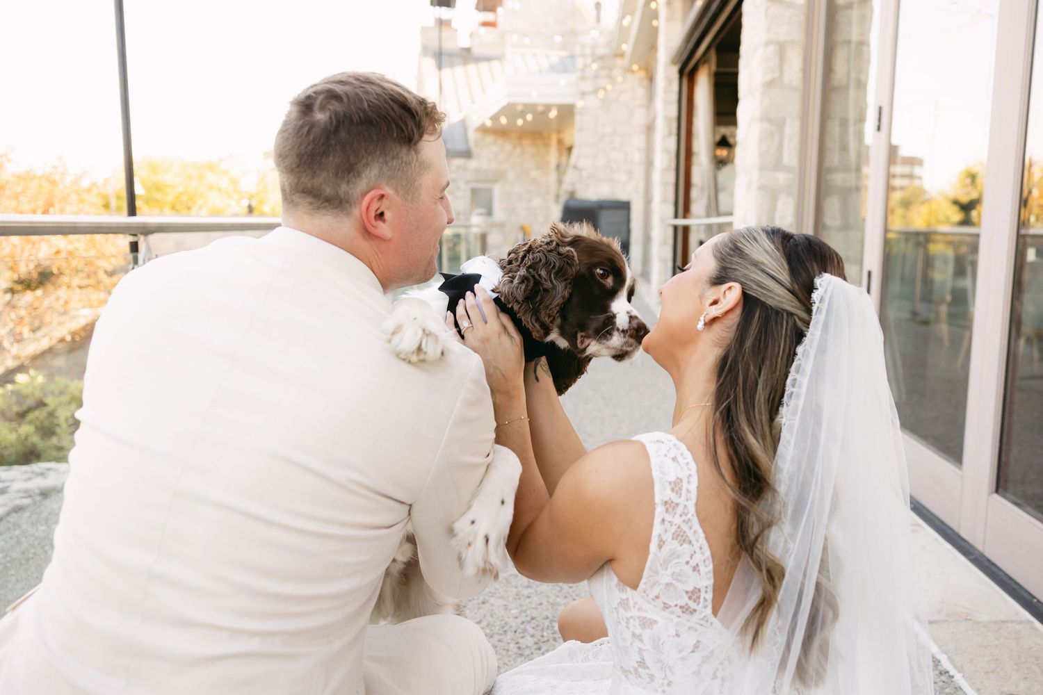 Wedding couple shares candid moment during outdoor photo session.