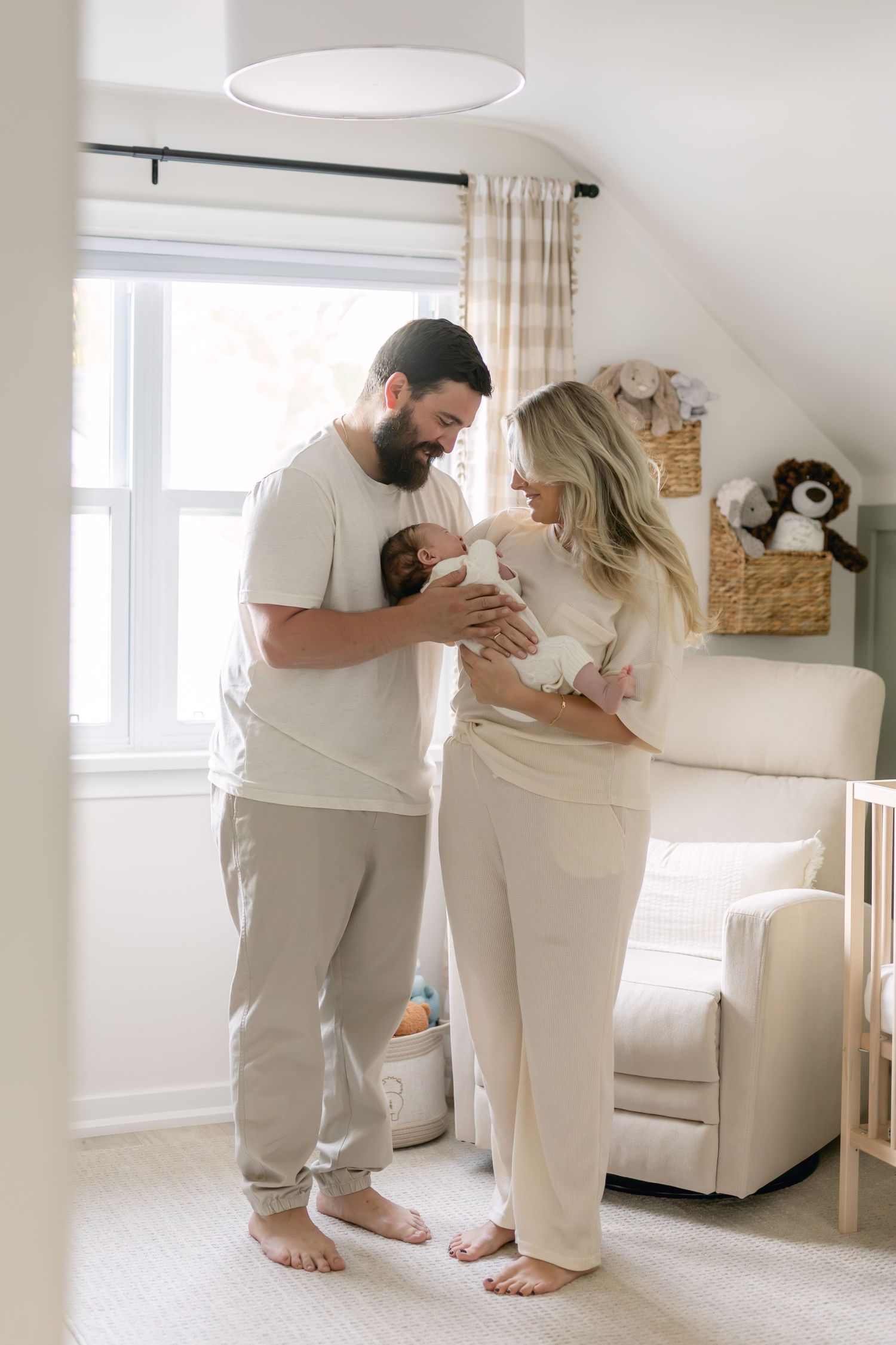 Intimate family moment captured in a bright white modern living room setting.