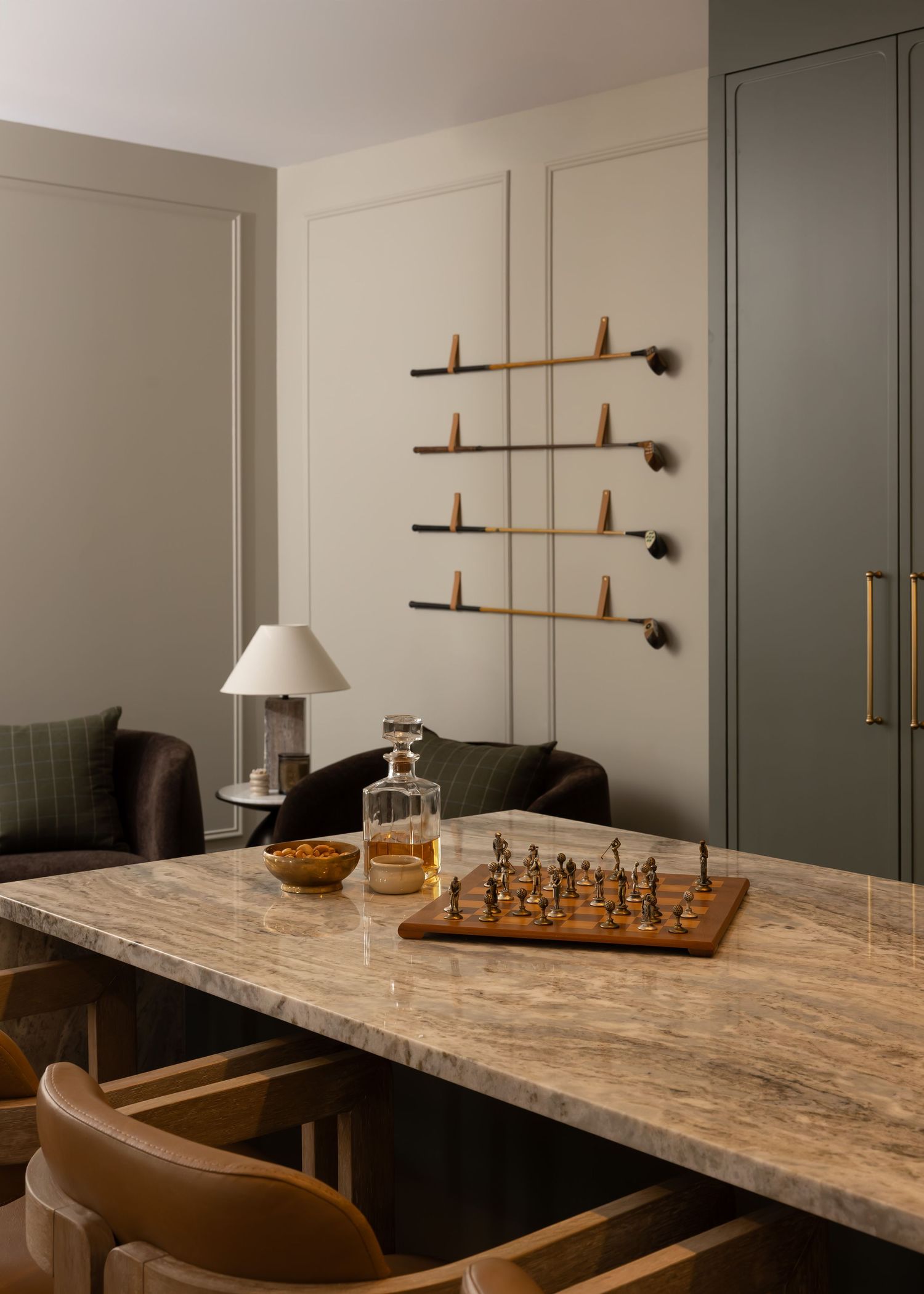 Modern game area with marble table, chess set, and wooden wall-mounted accents.