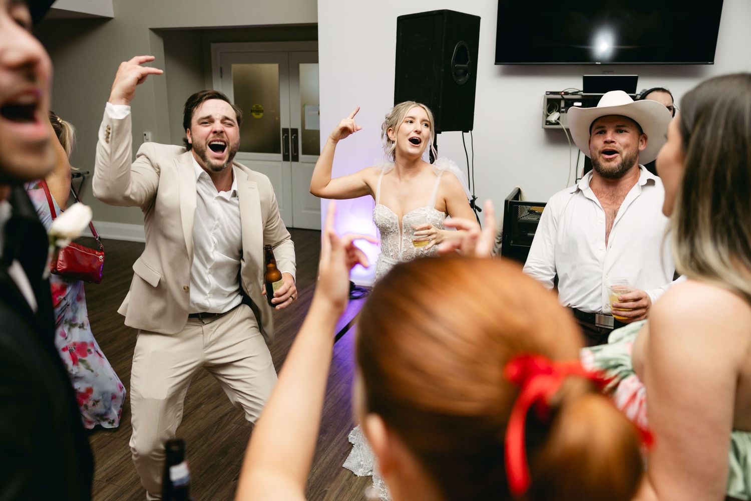 Wedding reception dance floor filled with guests enjoying the celebration.