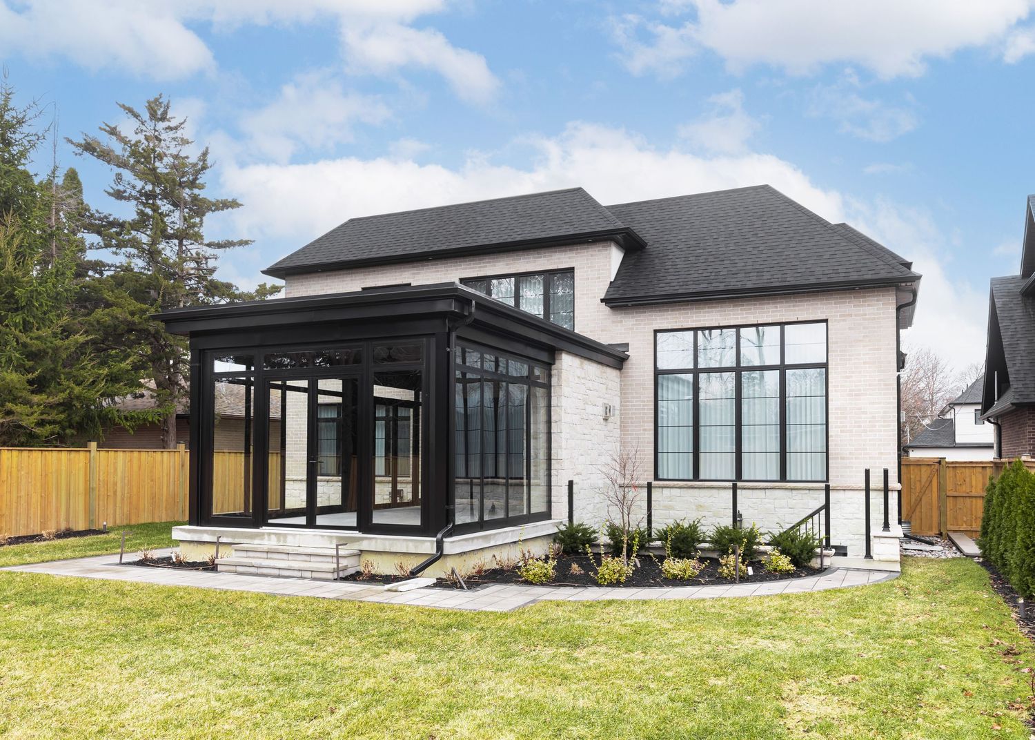 Panoramic view of a modern residential property with landscaped yard and architectural details.