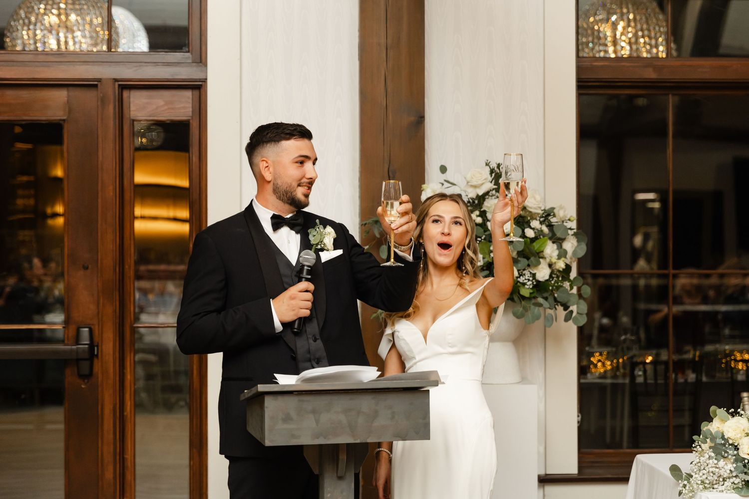 Elegant wedding venue interior with rustic wooden details and warm lighting.