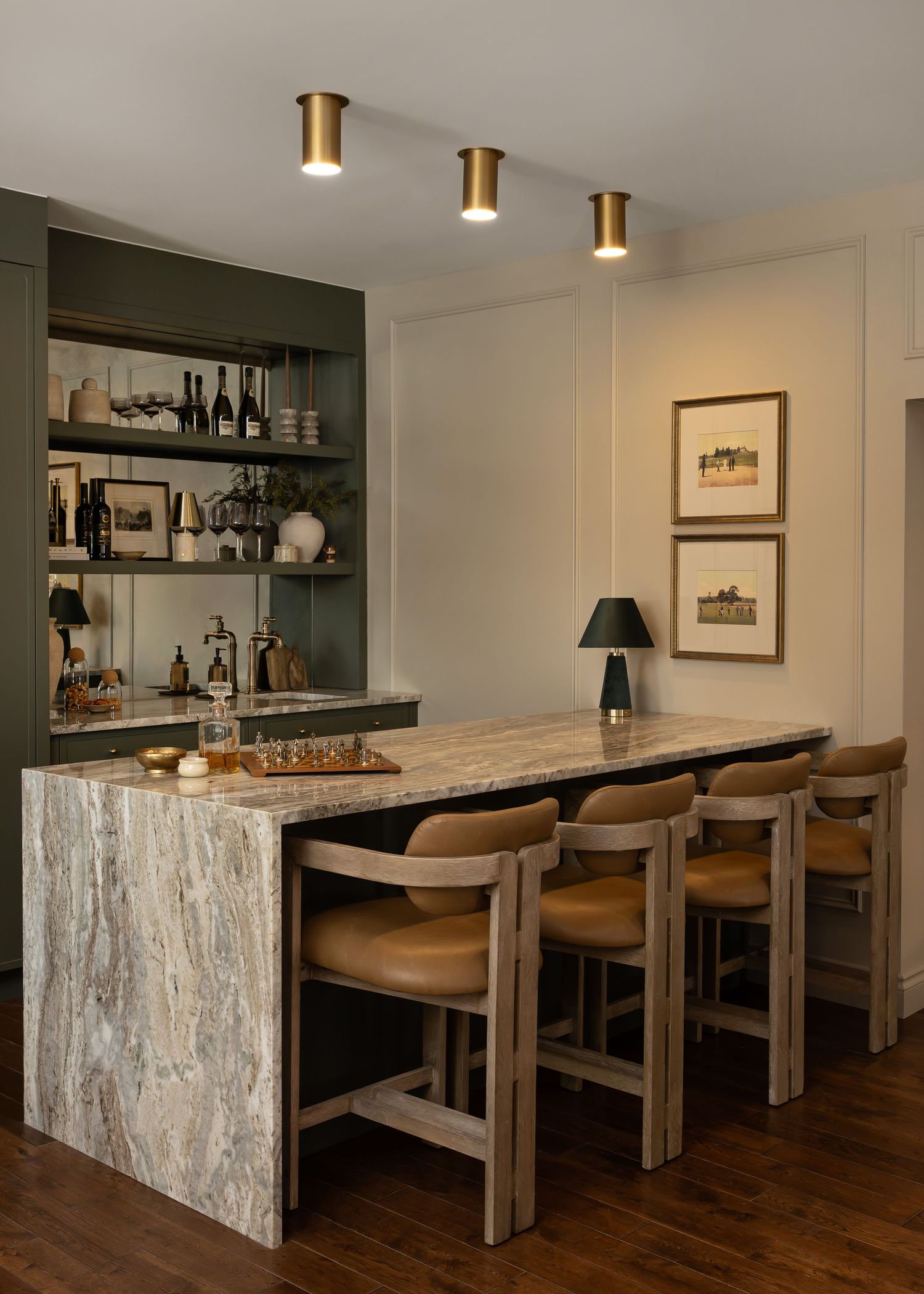 Elegant bar seating area with leather stools and marble countertops in a contemporary setting.