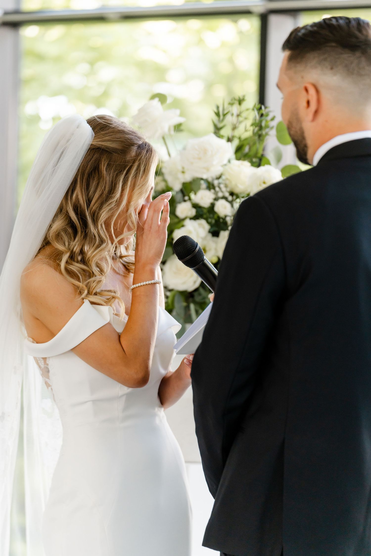 Intimate wedding ceremony moments captured in bright indoor venue.
