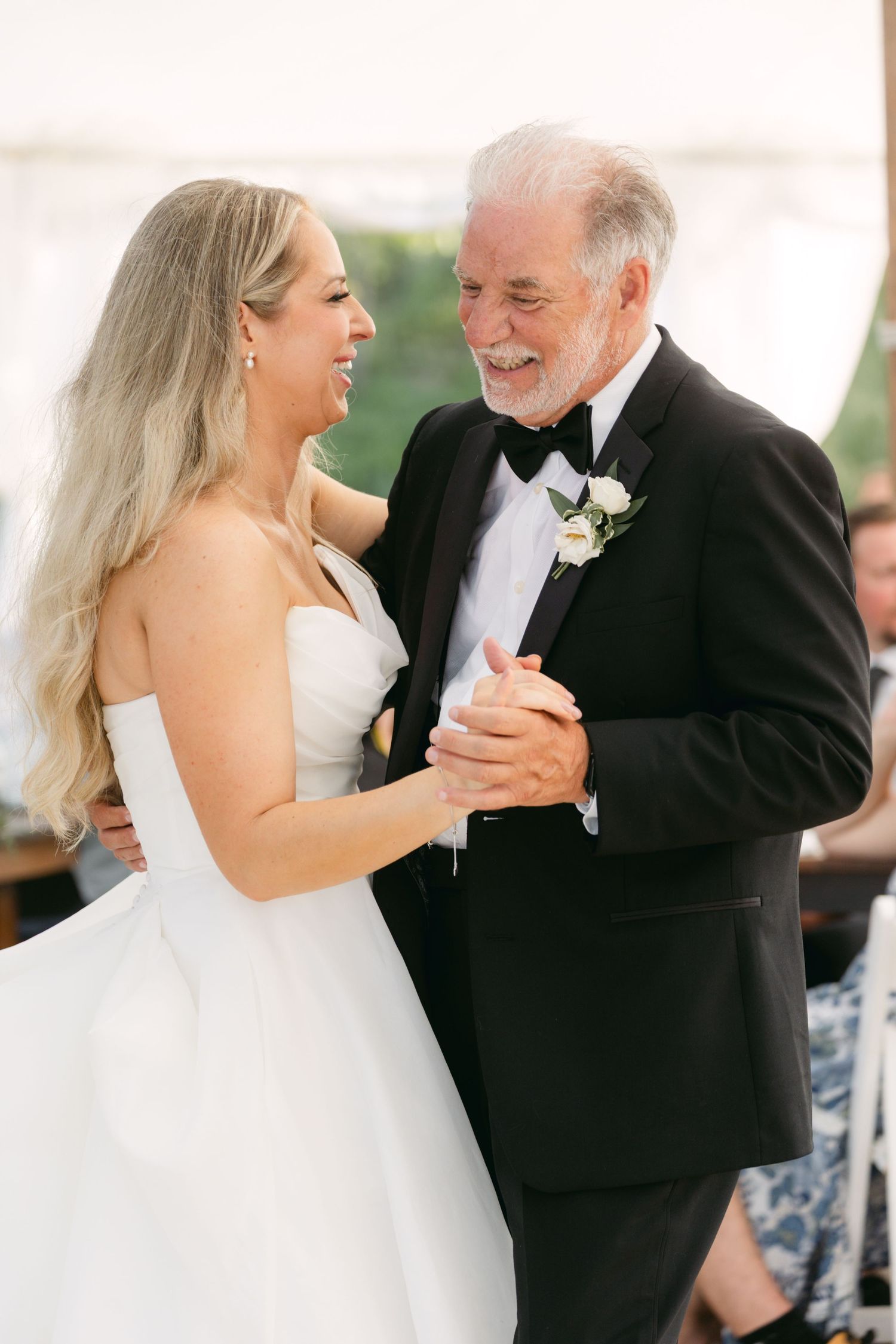 Special dance moment shared during wedding reception under white tent.