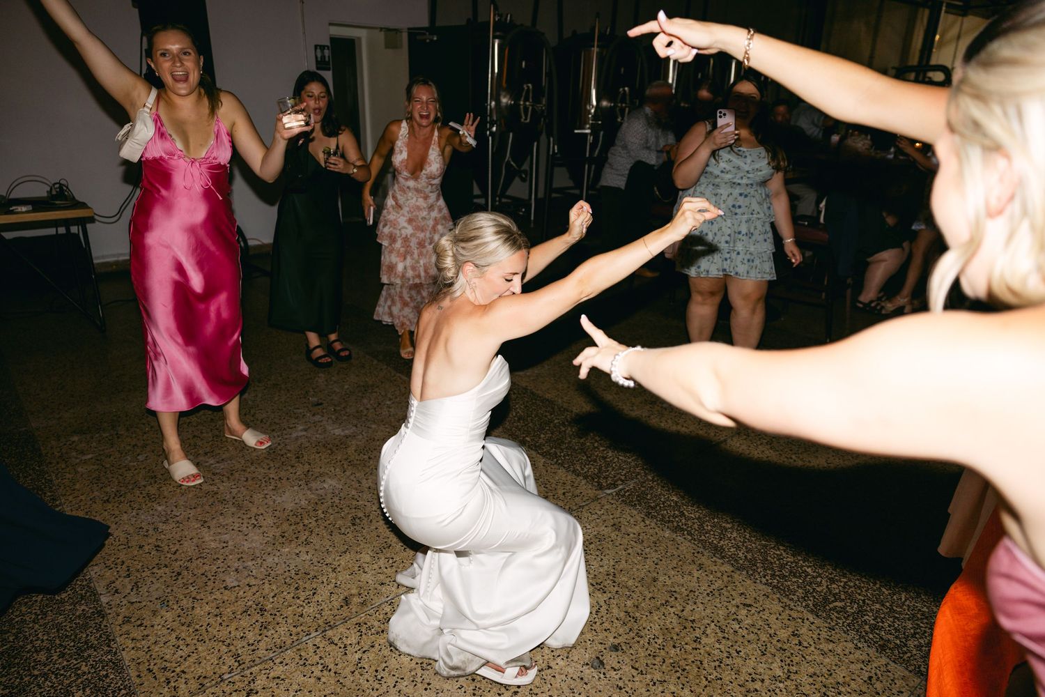 Dance floor filled with celebration and movement under evening lighting.