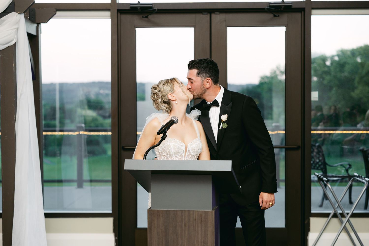 Modern wedding venue interior with floor-to-ceiling windows and wooden accents.