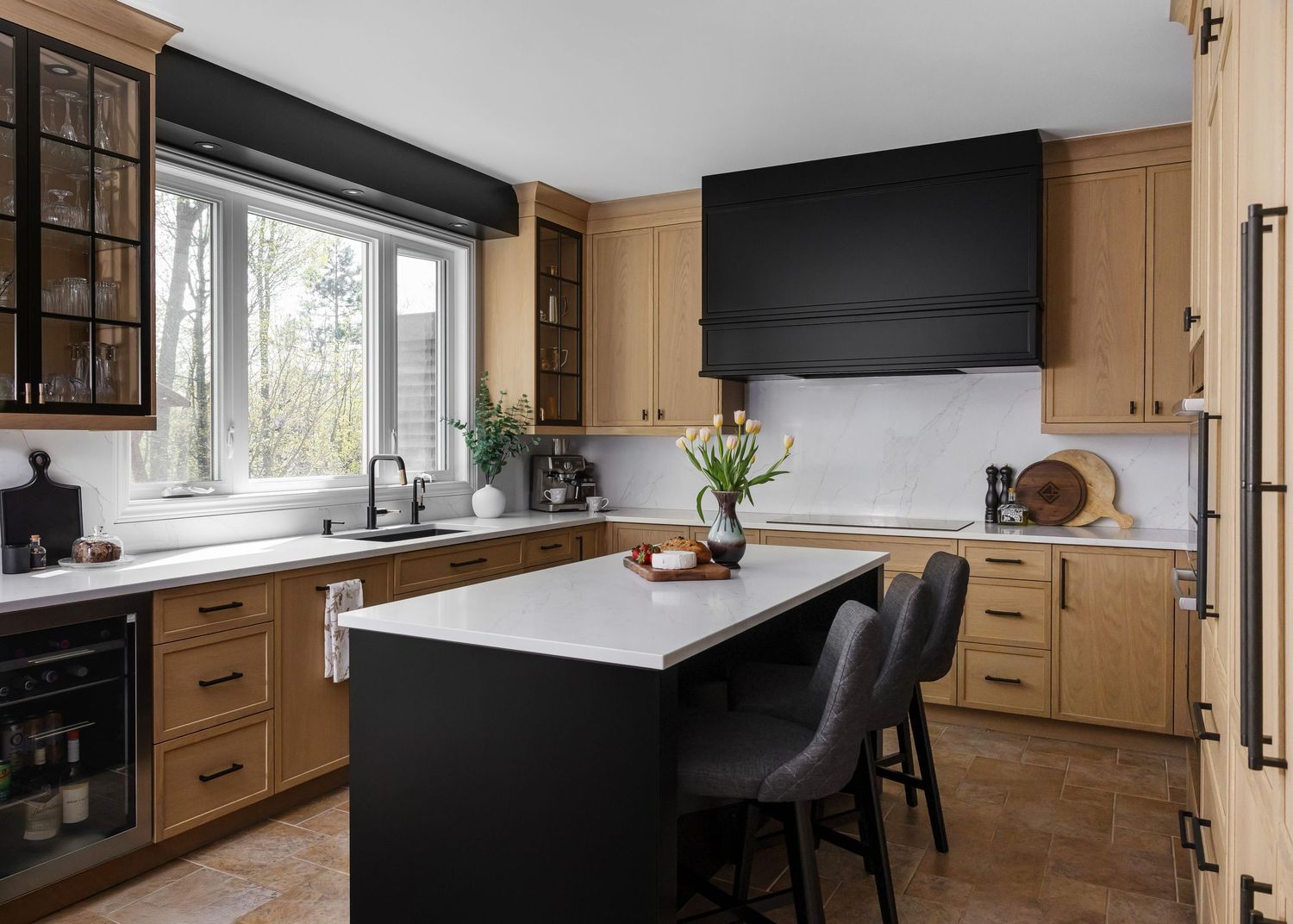 Contemporary kitchen design showcasing wood cabinetry, black appliances, and a minimalist aesthetic.