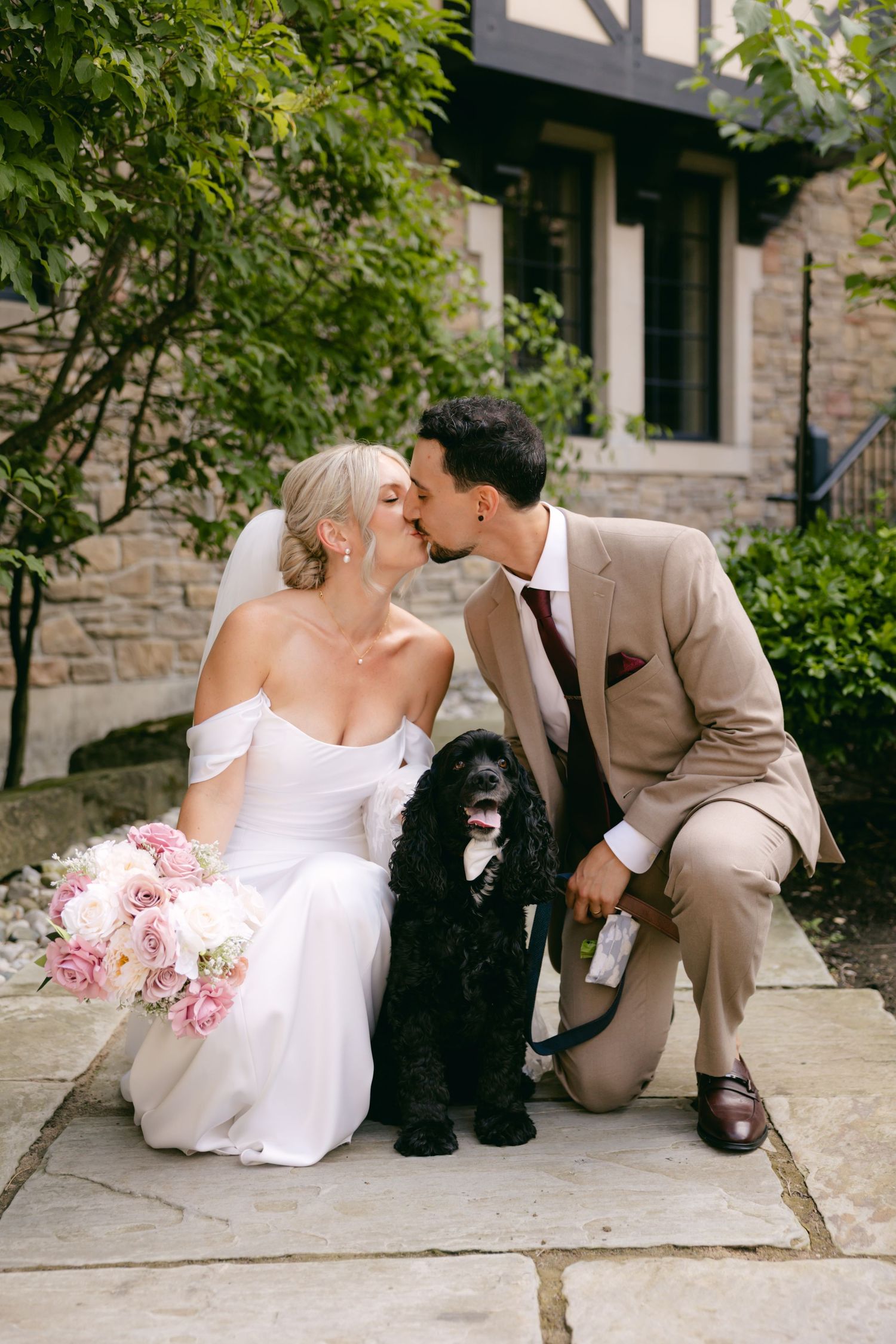 A series of romantic wedding photos featuring a couple and their black dog on stone steps.