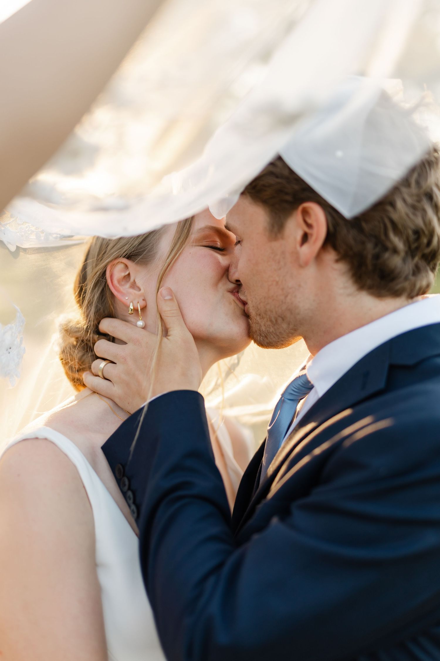 An intimate wedding portrait captures a tender moment between the couple.