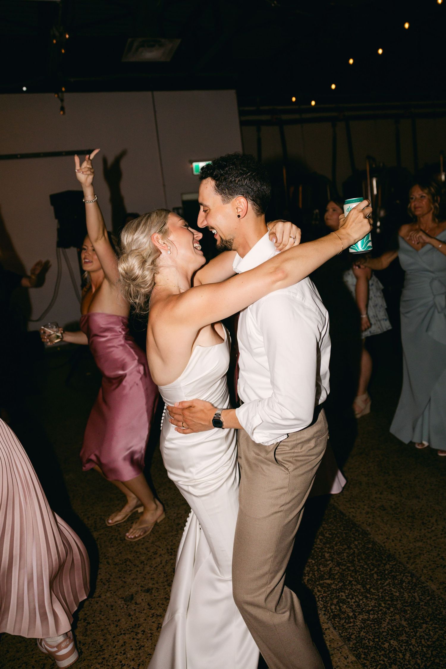 Wedding reception dance floor filled with couples dancing in formal attire.