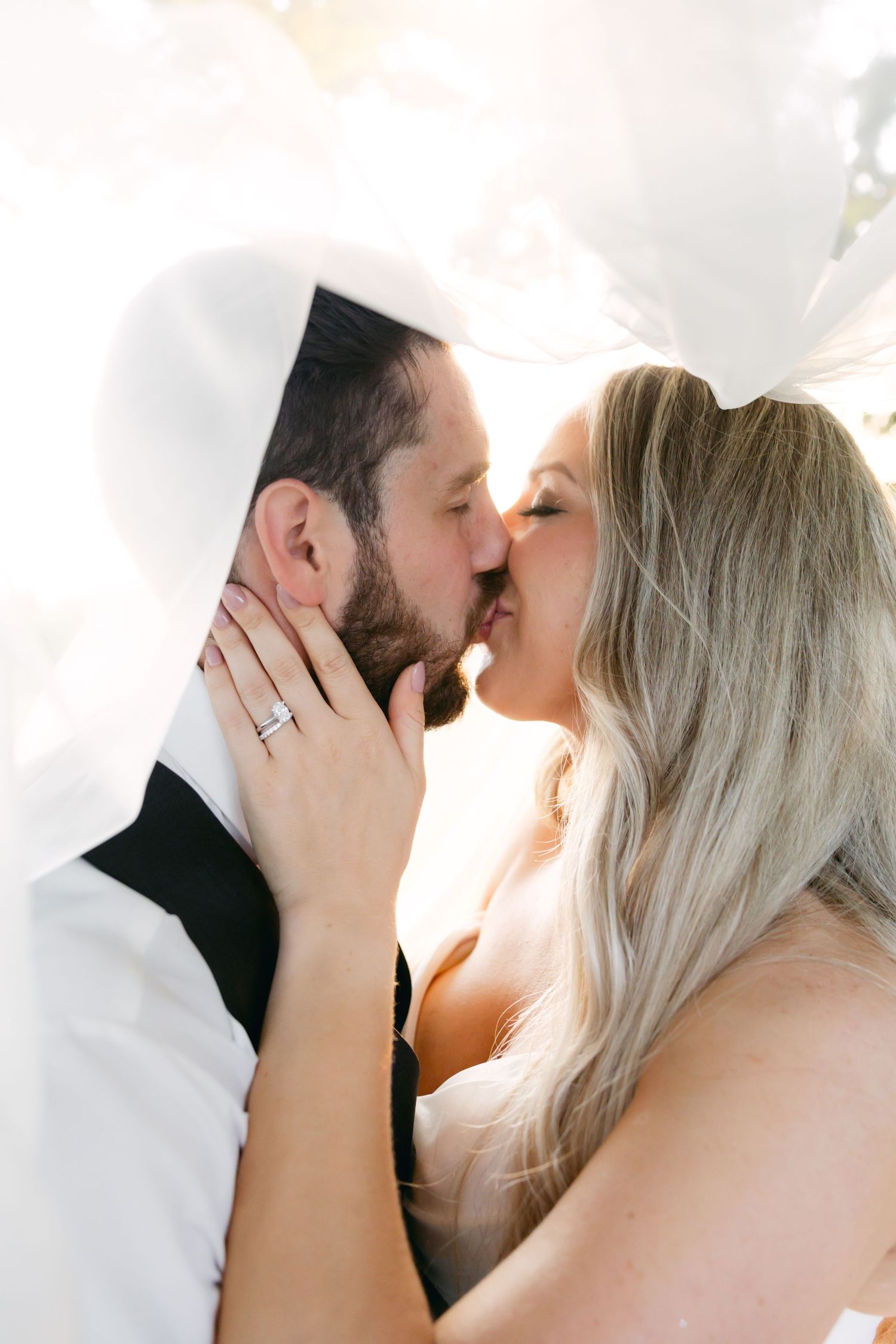 Intimate close-up wedding portrait showing tender moment between couple.
