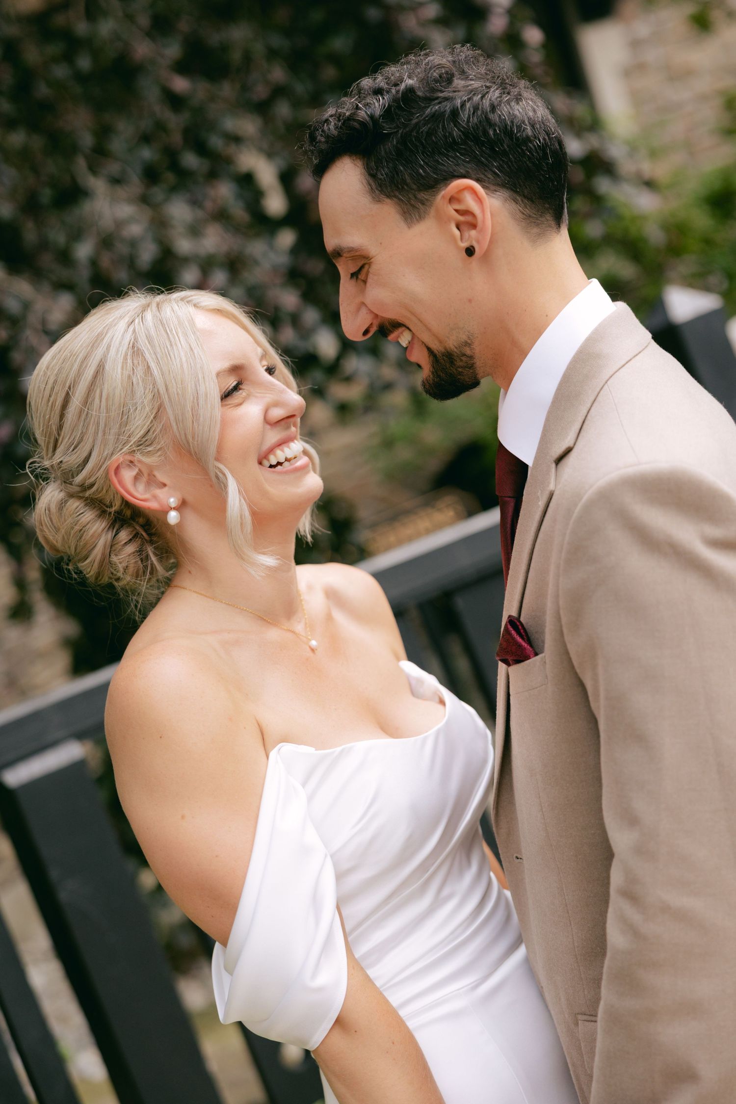 Candid wedding moment showing genuine laughter and joy between couple.