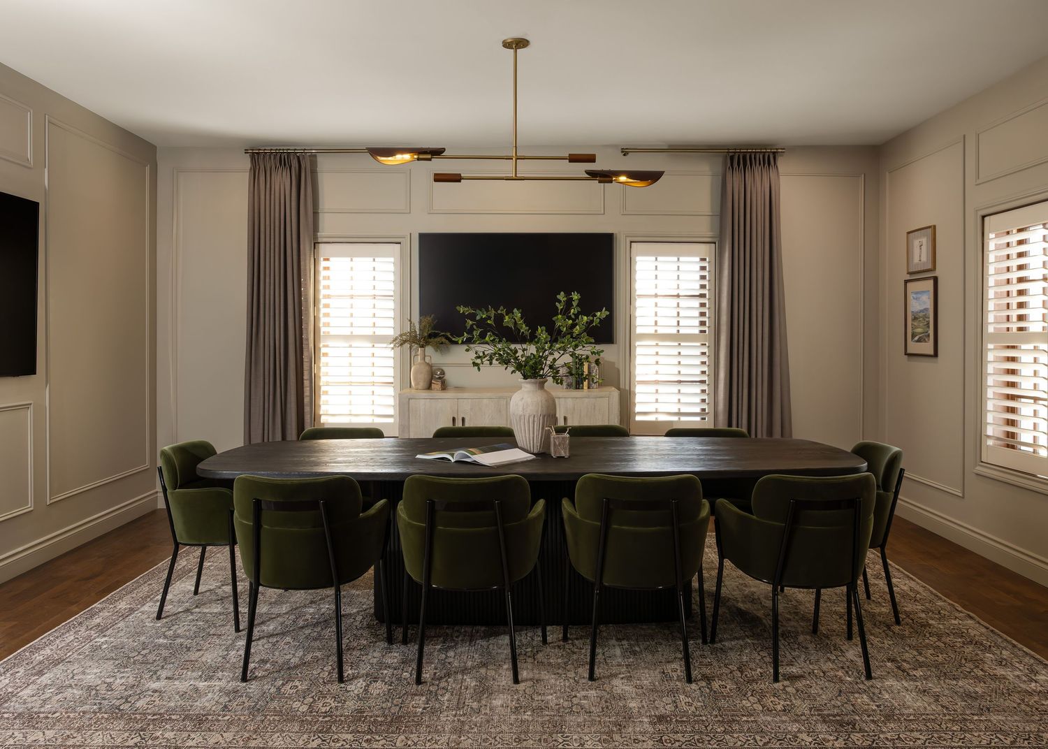 Spacious dining area with plush seating, plantation shutters, and neutral color scheme.