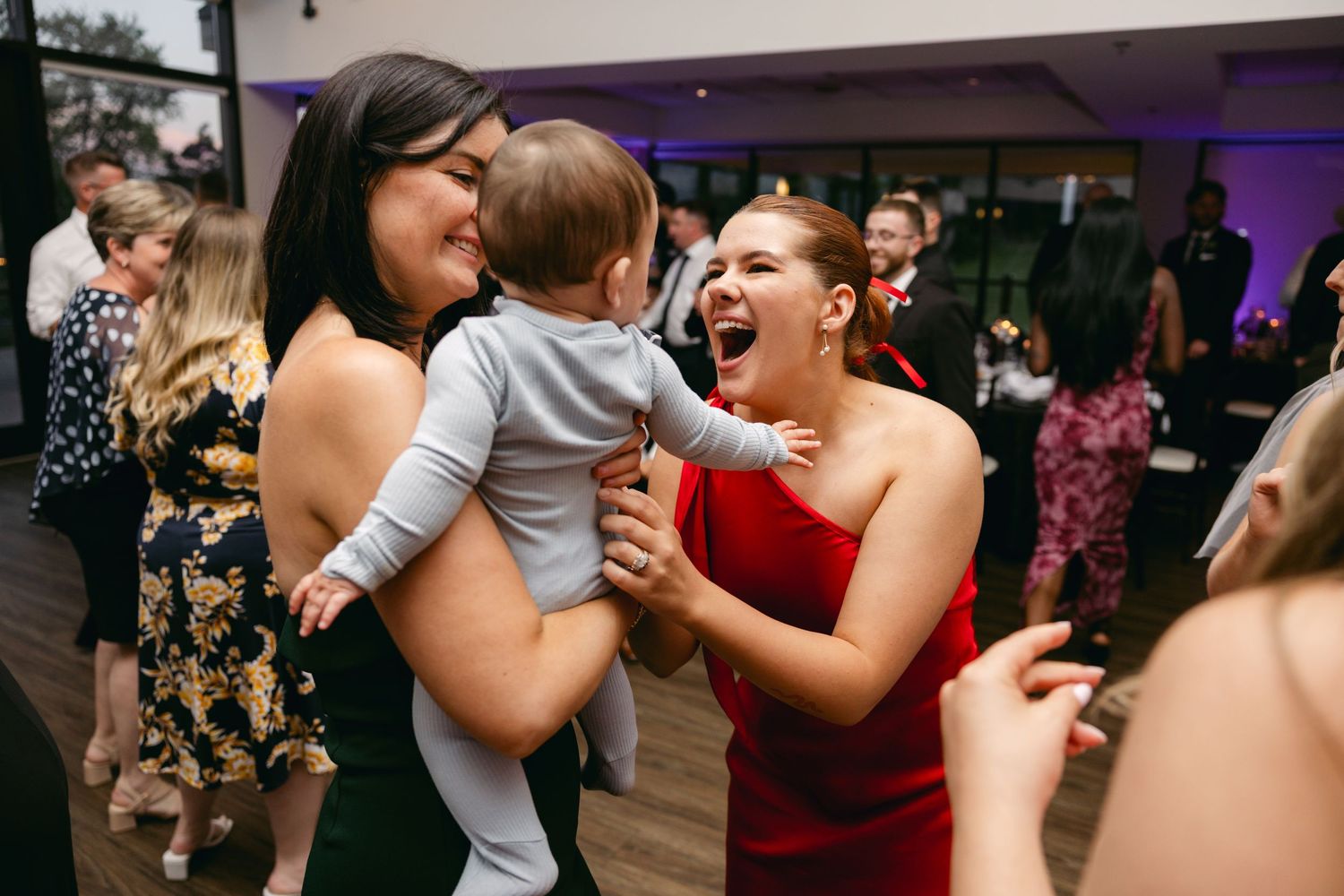Candid moments of wedding guests laughing and dancing together at an indoor reception.