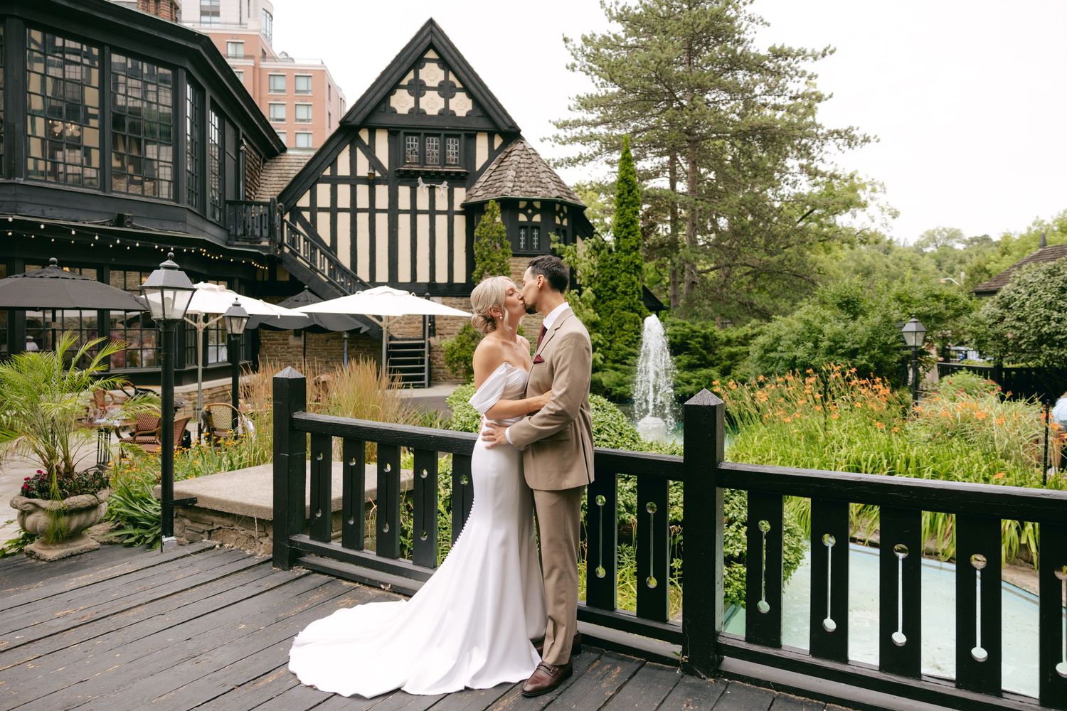 A couple strolls along a scenic garden pathway during their wedding celebration.