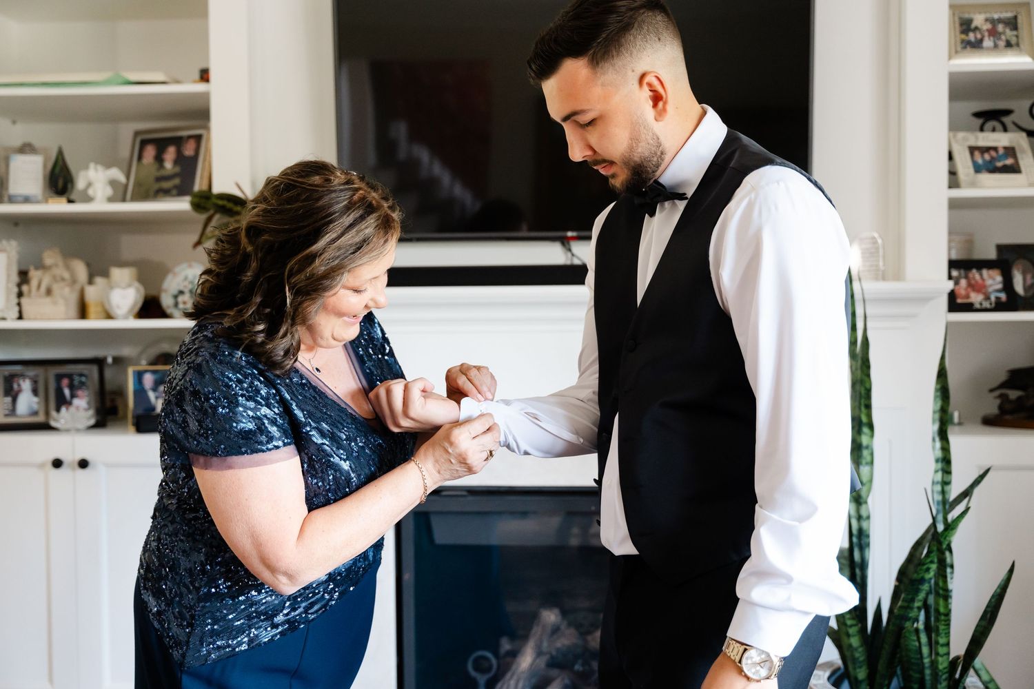 A couple shares an intimate dance moment in formal wedding attire.