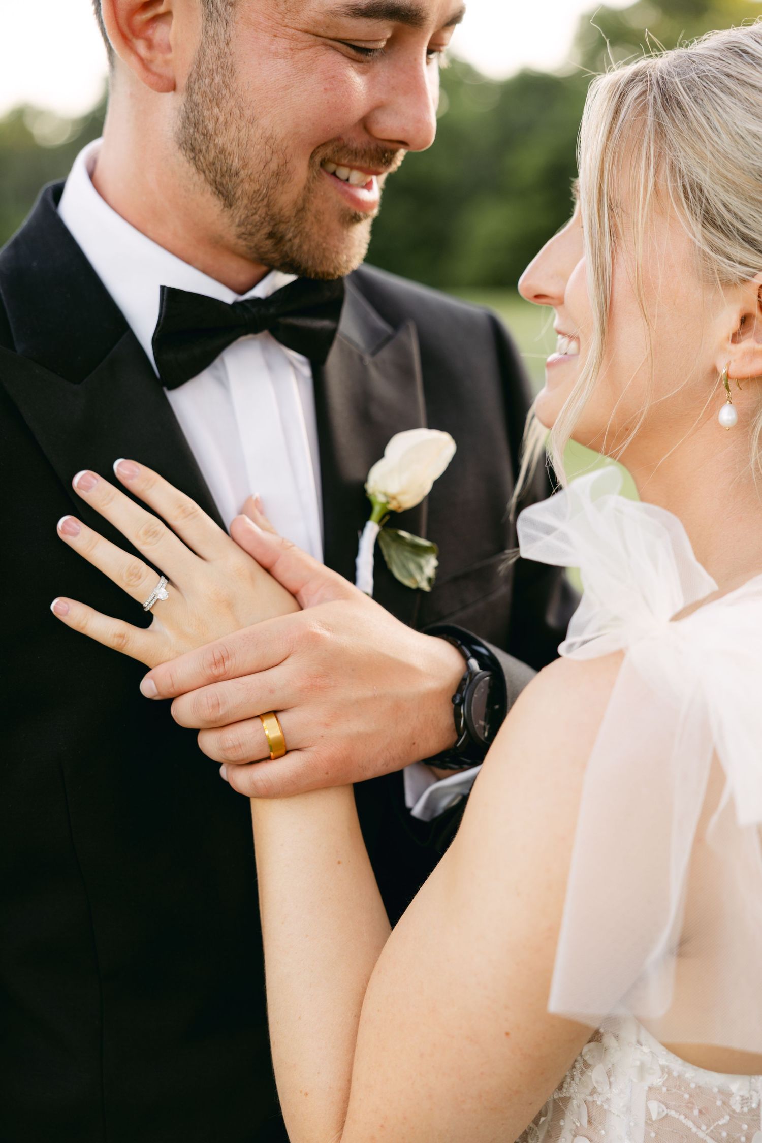 Detail shots of tender moments and wedding rings during an outdoor photo session.