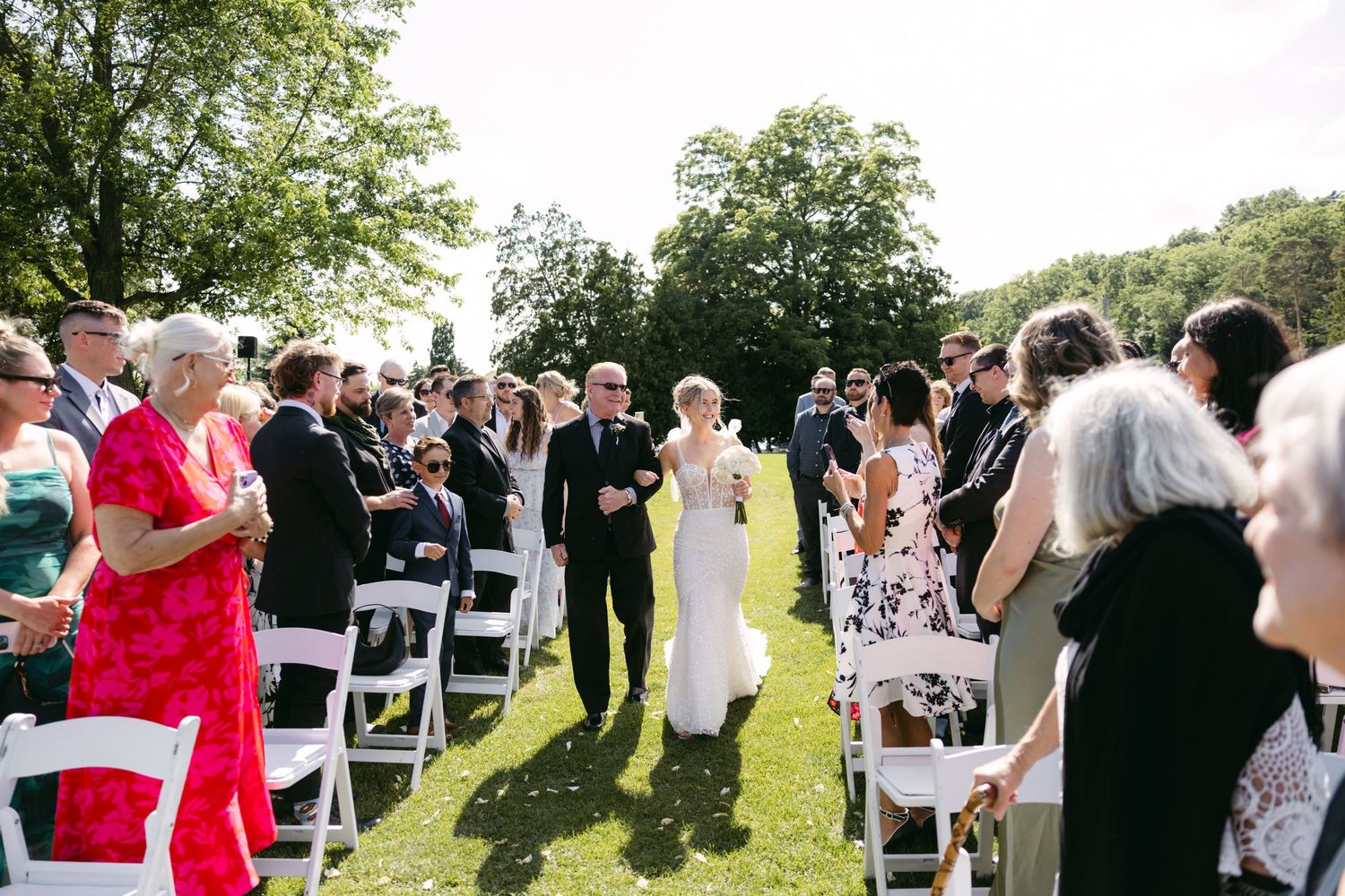Candid shots of wedding guests enjoying themselves during an outdoor celebration.