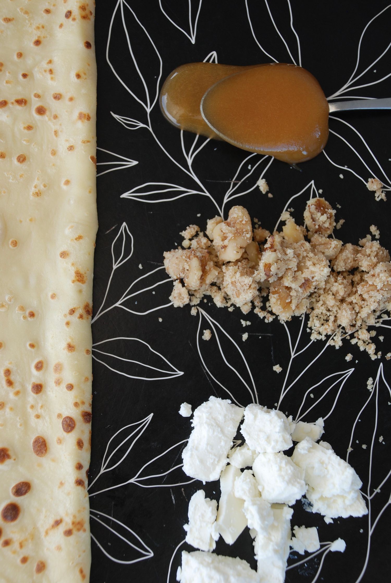 Crepe with caramel sauce, walnuts, and goat's cheese in a close-up shot