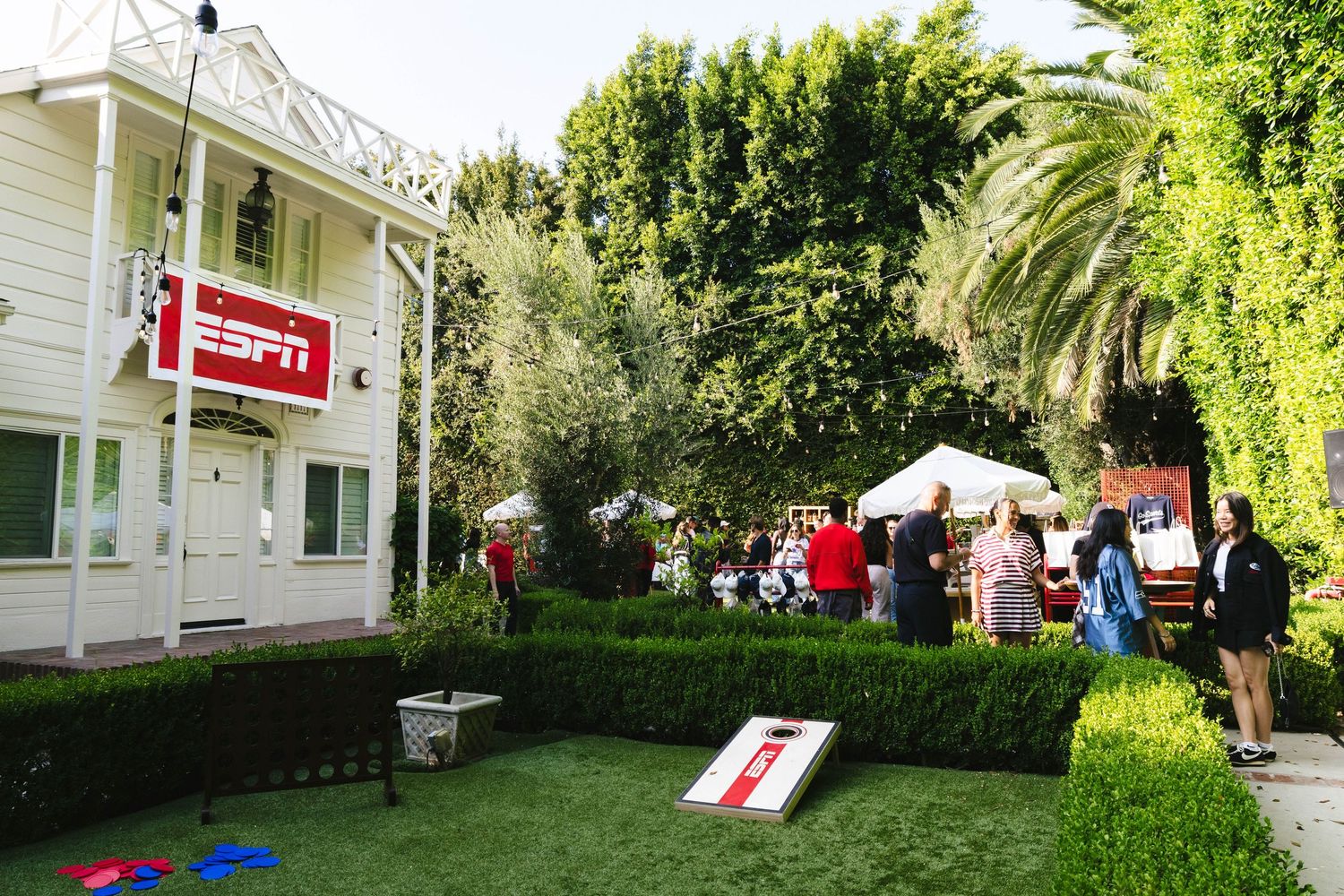 Outdoor event space with white buildings and green landscaping.